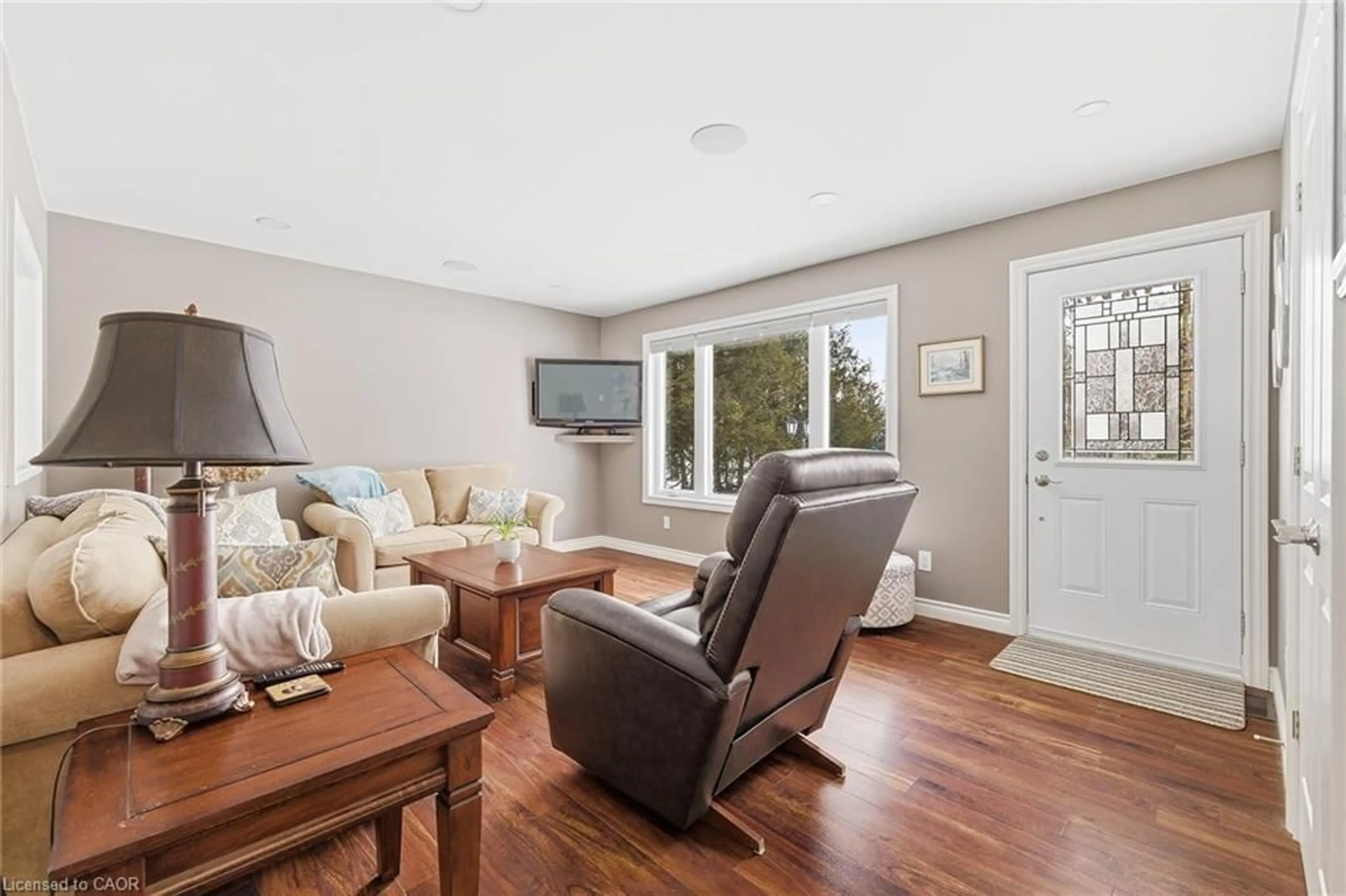 Living room with furniture, wood/laminate floor for 7315 Sideroad 15, Moorefield Ontario N0G 2K0