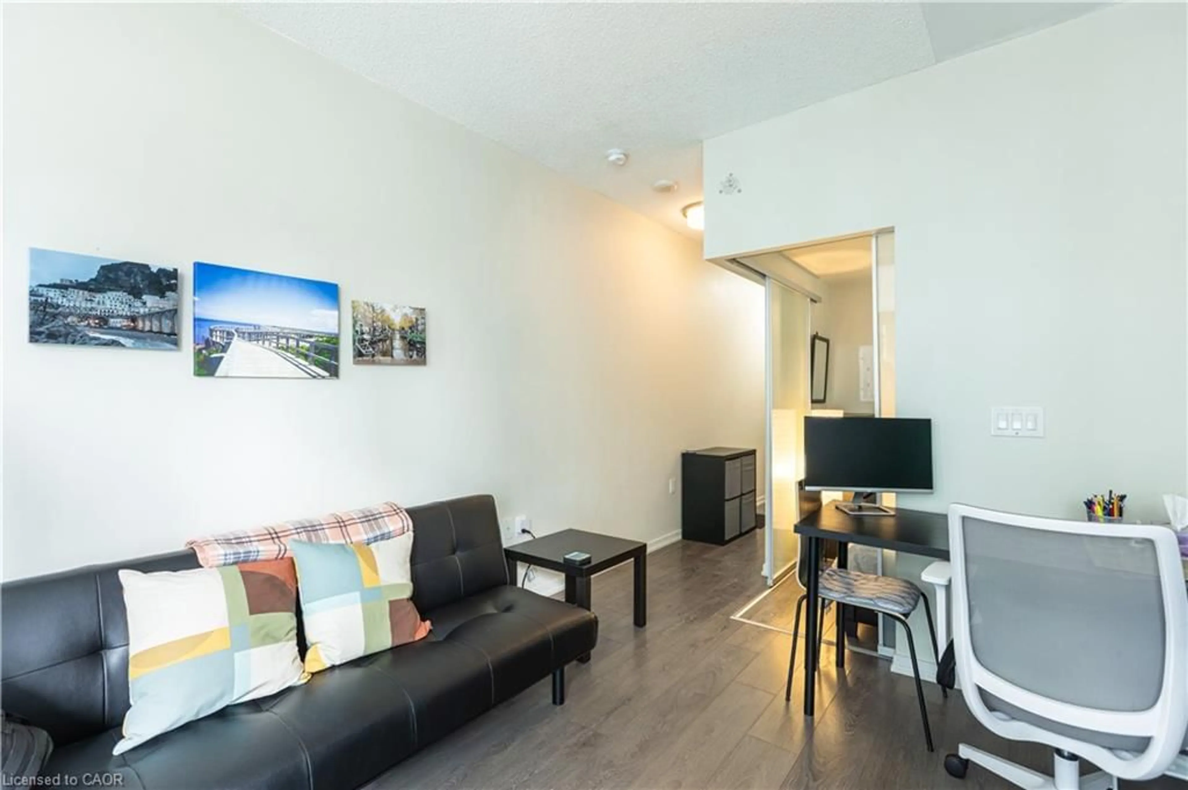 Living room with furniture, wood/laminate floor for 36 Lisgar St #825, Toronto Ontario M6J 0C7