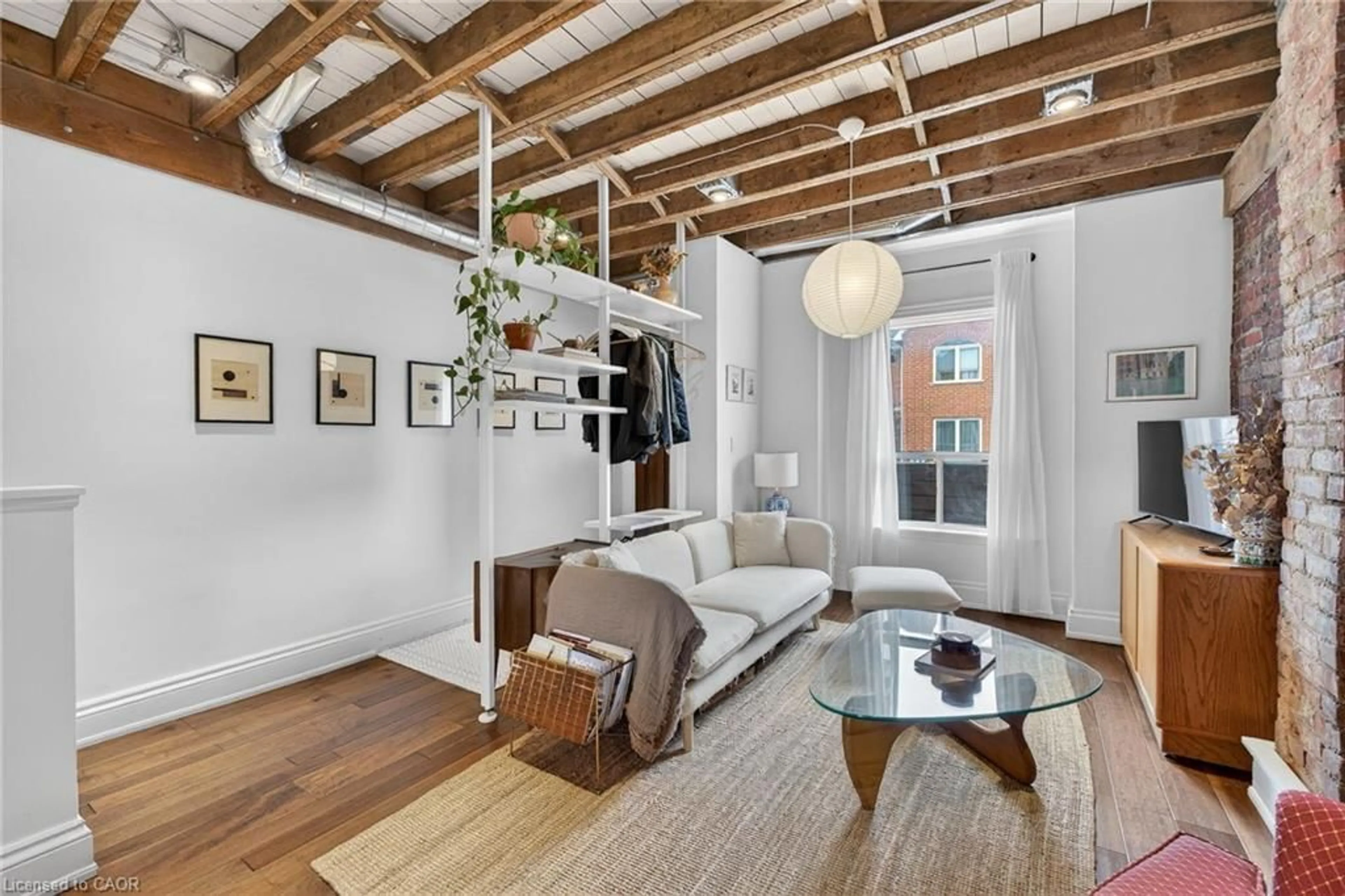 Living room with furniture, cement floor for 112 Burton St, Hamilton Ontario L8L 3R5