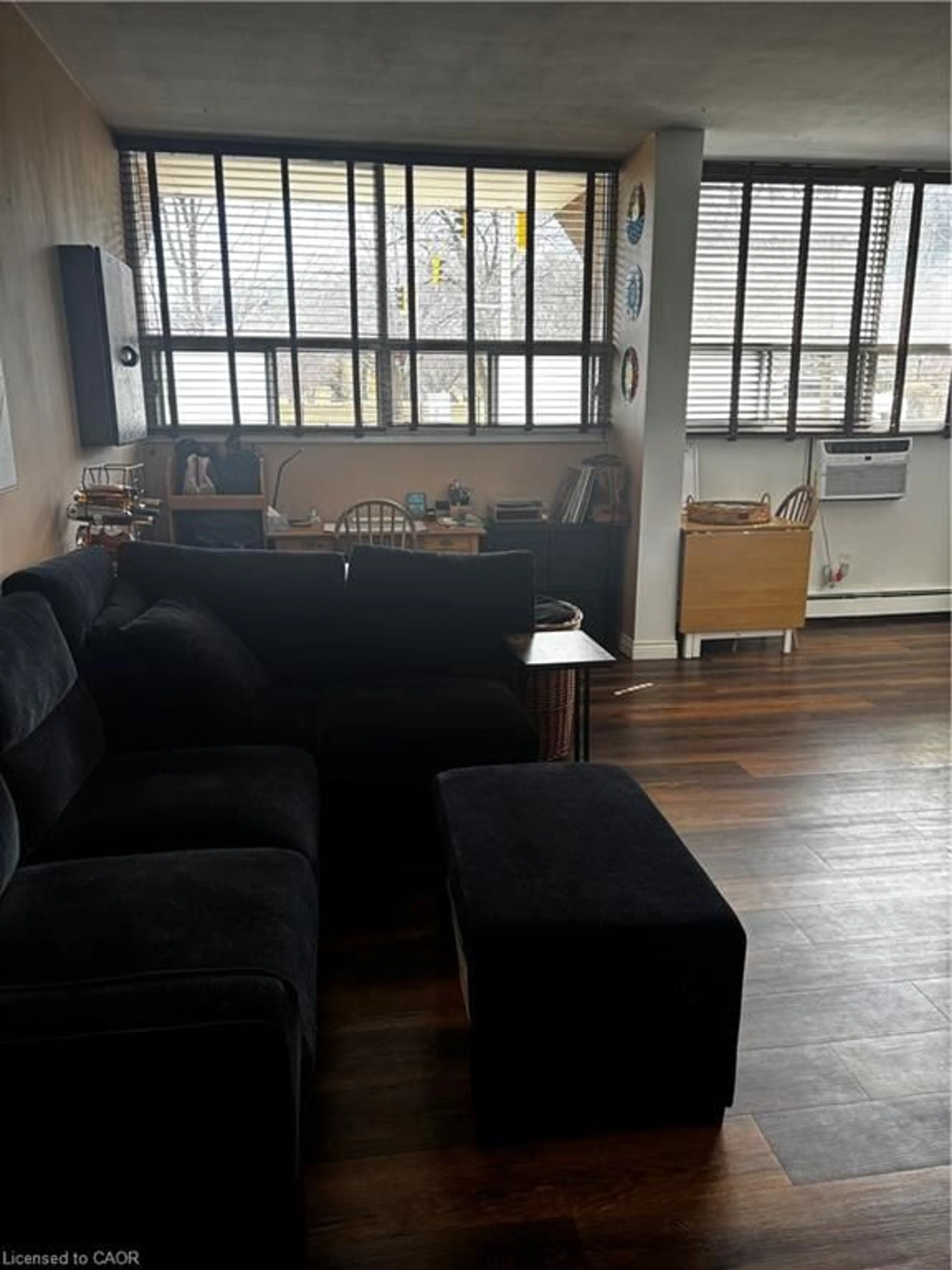 Living room with furniture, floor is not visible for 1950 Main St #102, Hamilton Ontario L8S 4M9