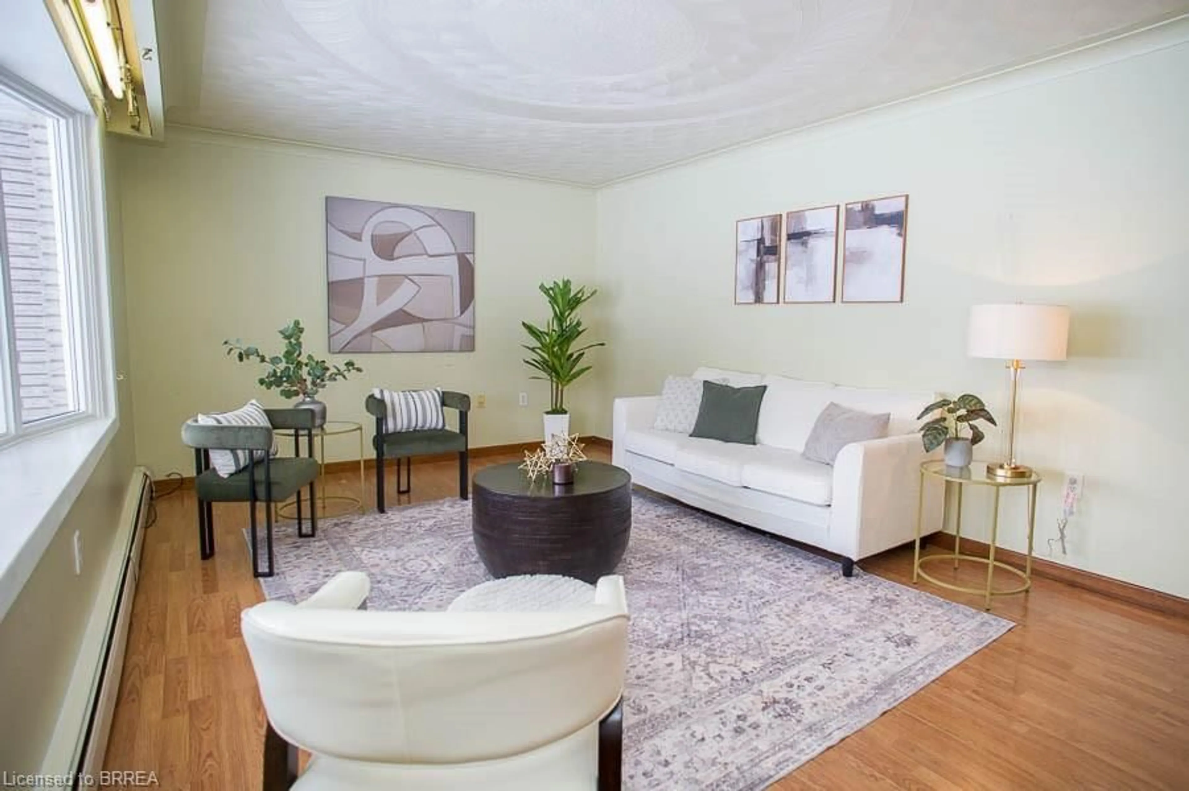 Living room with furniture, wood/laminate floor for 104 Hillside Ave, Delhi Ontario N4B 1Y7