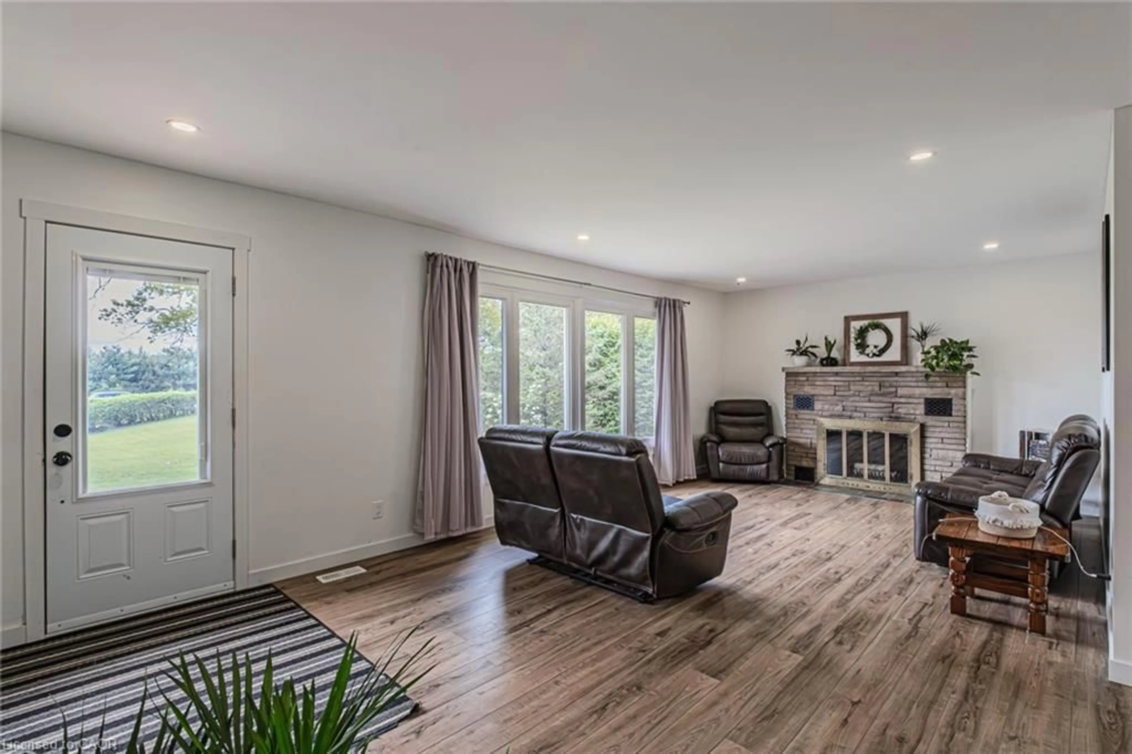 Living room with furniture, wood/laminate floor for 2364 Windham West Quarterline Rd, Simcoe Ontario N3Y 4J9