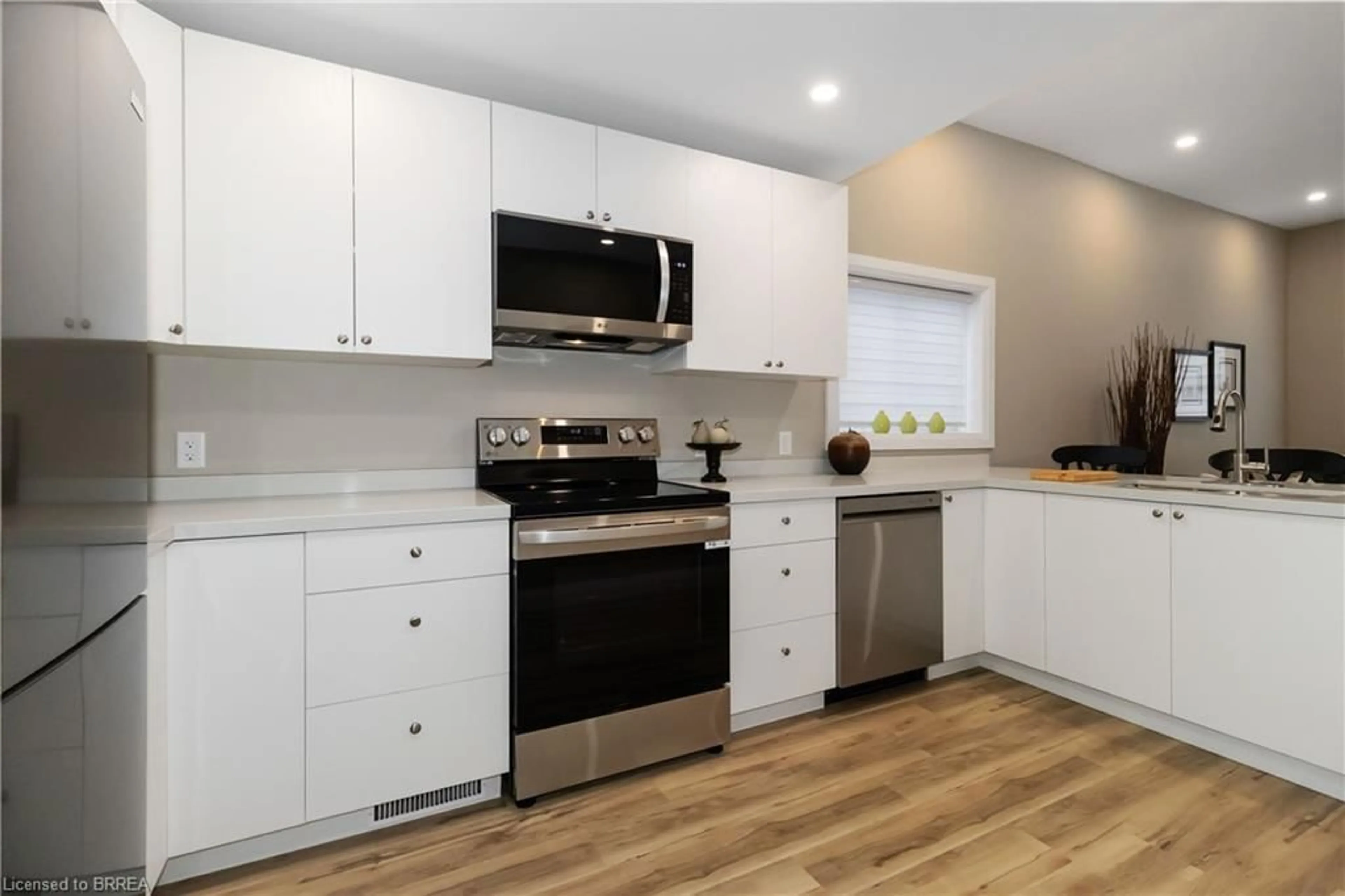 Open concept kitchen, wood/laminate floor for 16 Mt. Pleasant St, Brantford Ontario N3T 1S5