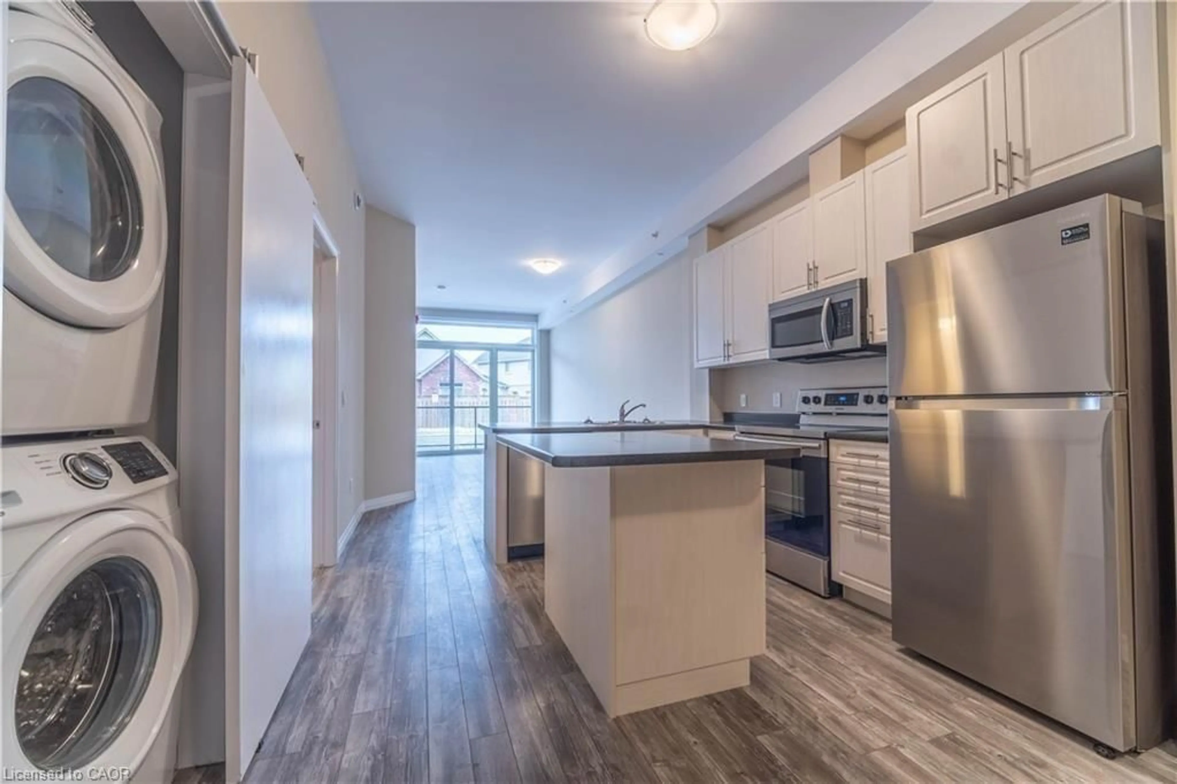 Open concept kitchen, wood/laminate floor for 85B Morrell St #112, Brantford Ontario N3T 4J6