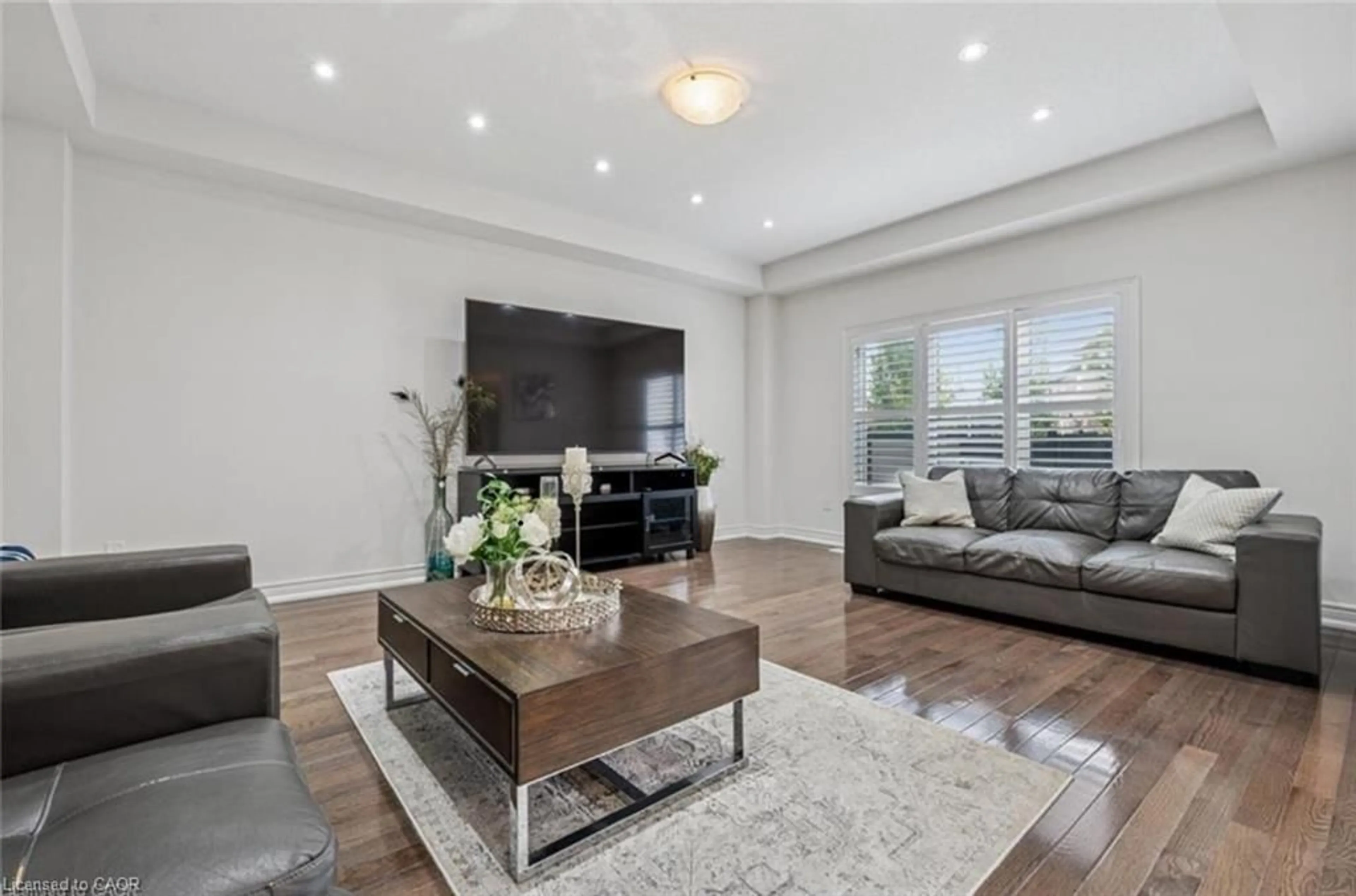 Living room with furniture, wood/laminate floor for 77 Eaglecrest St, Kitchener Ontario N2K 4K1