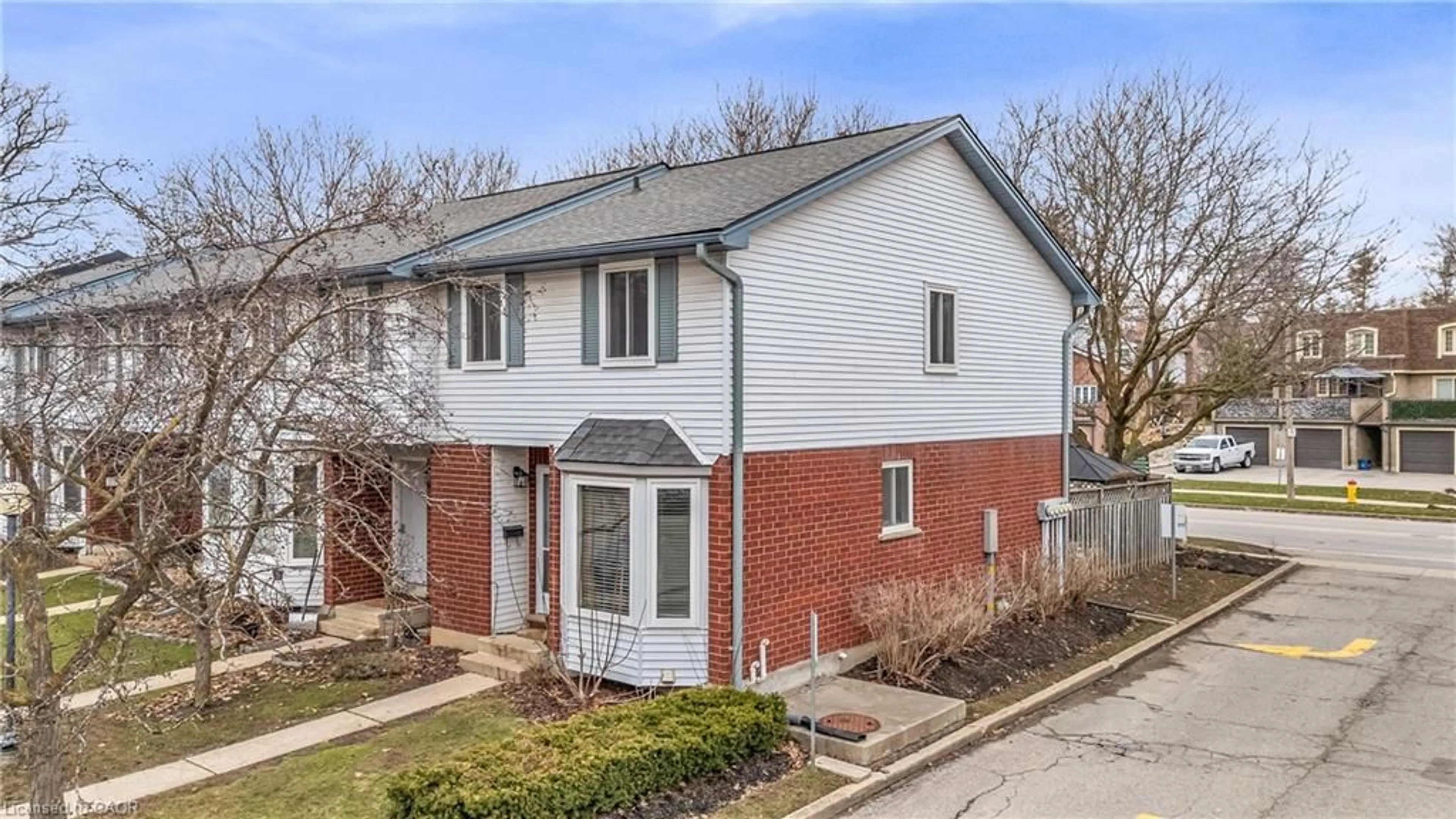 Home with brick exterior material, street for 219 Kingswood Dr #52, Kitchener Ontario N2E 3J5