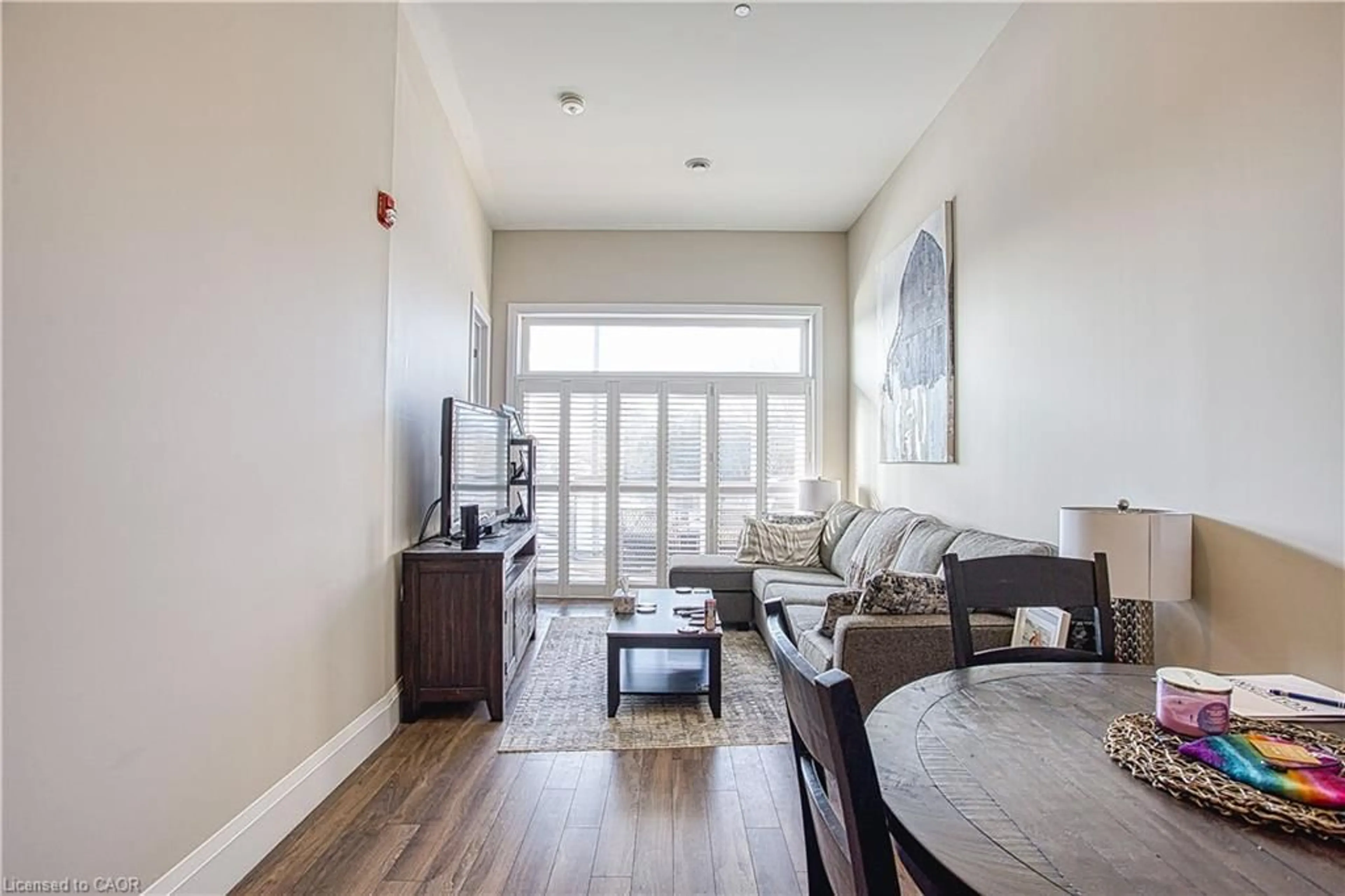 Living room with furniture, wood/laminate floor for 85 Morrell St #215A, Brantford Ontario N3T 4J6