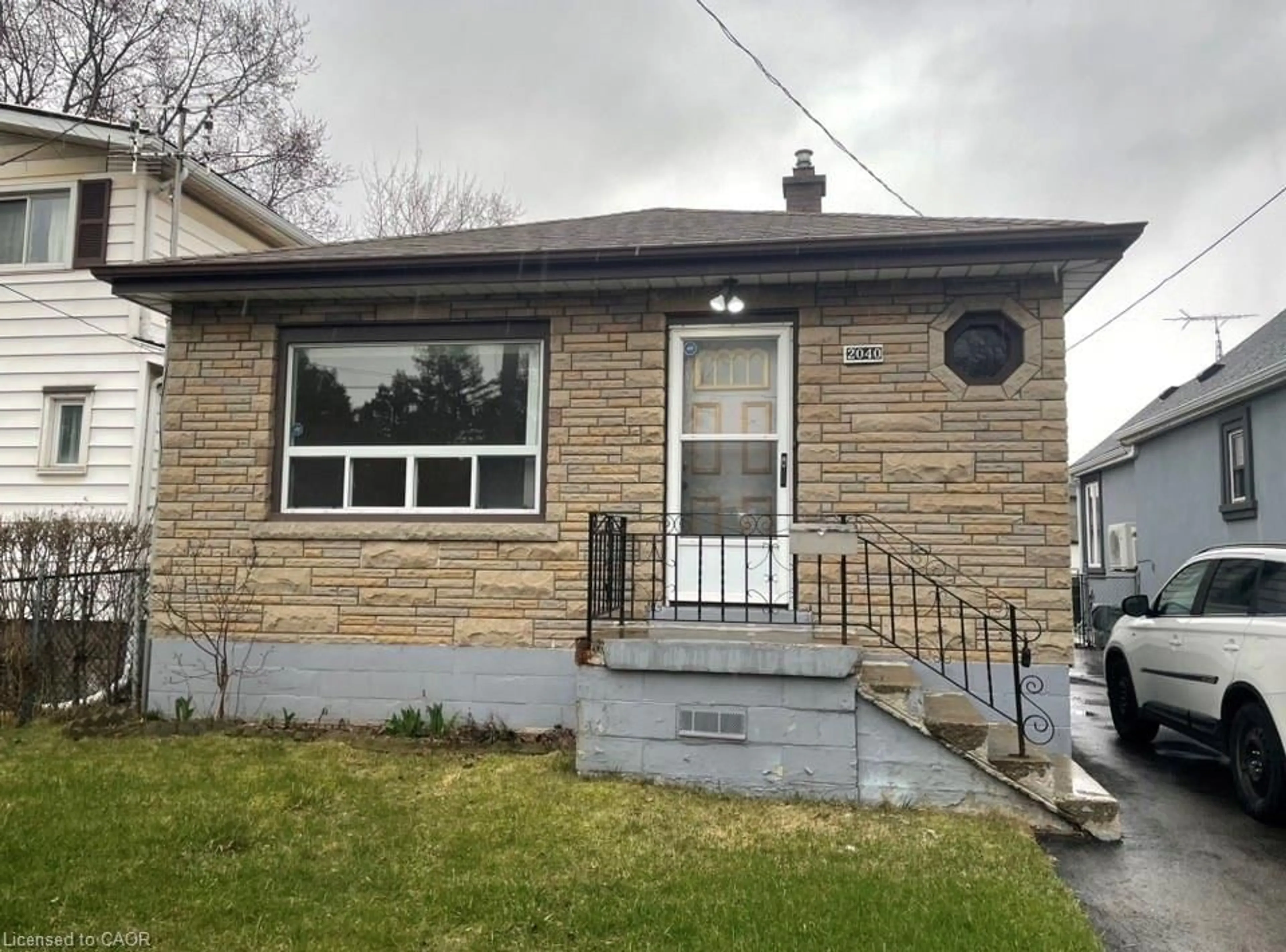 Home with brick exterior material, street for 2040 Barton St, Hamilton Ontario L8H 2Z2