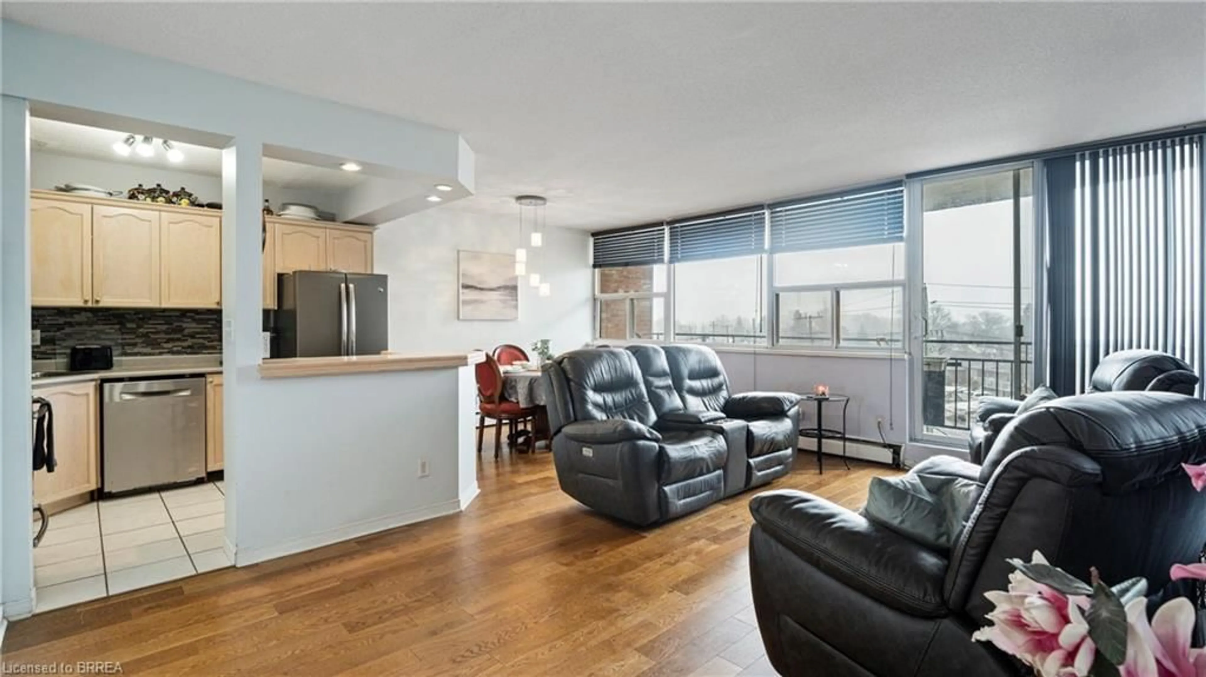 Living room with furniture, wood/laminate floor for 293 Mohawk Rd #501, Hamilton Ontario L9A 2J1