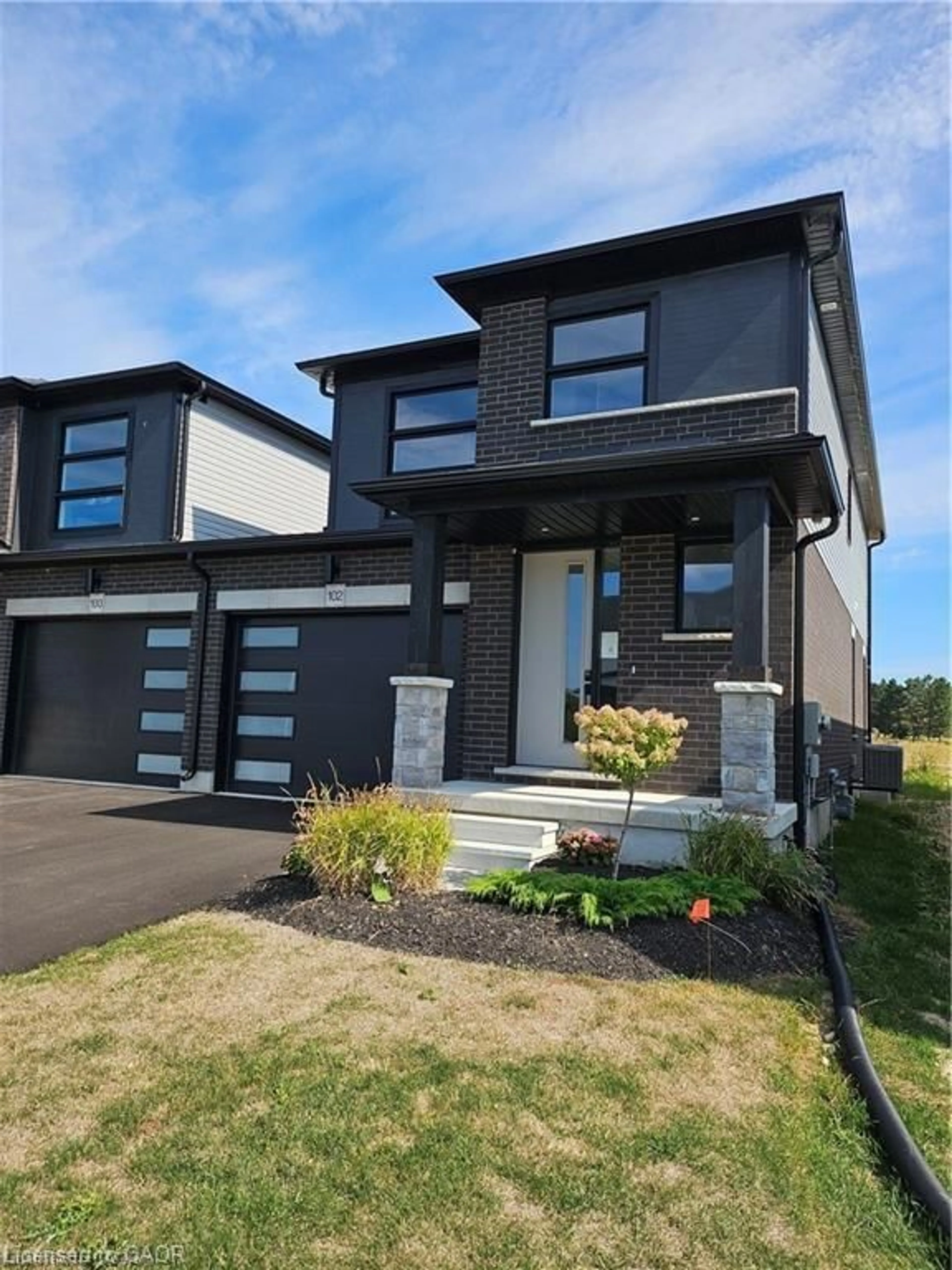 Home with brick exterior material, street for 102 Thackeray Way, Harriston Ontario N0G 1Z0