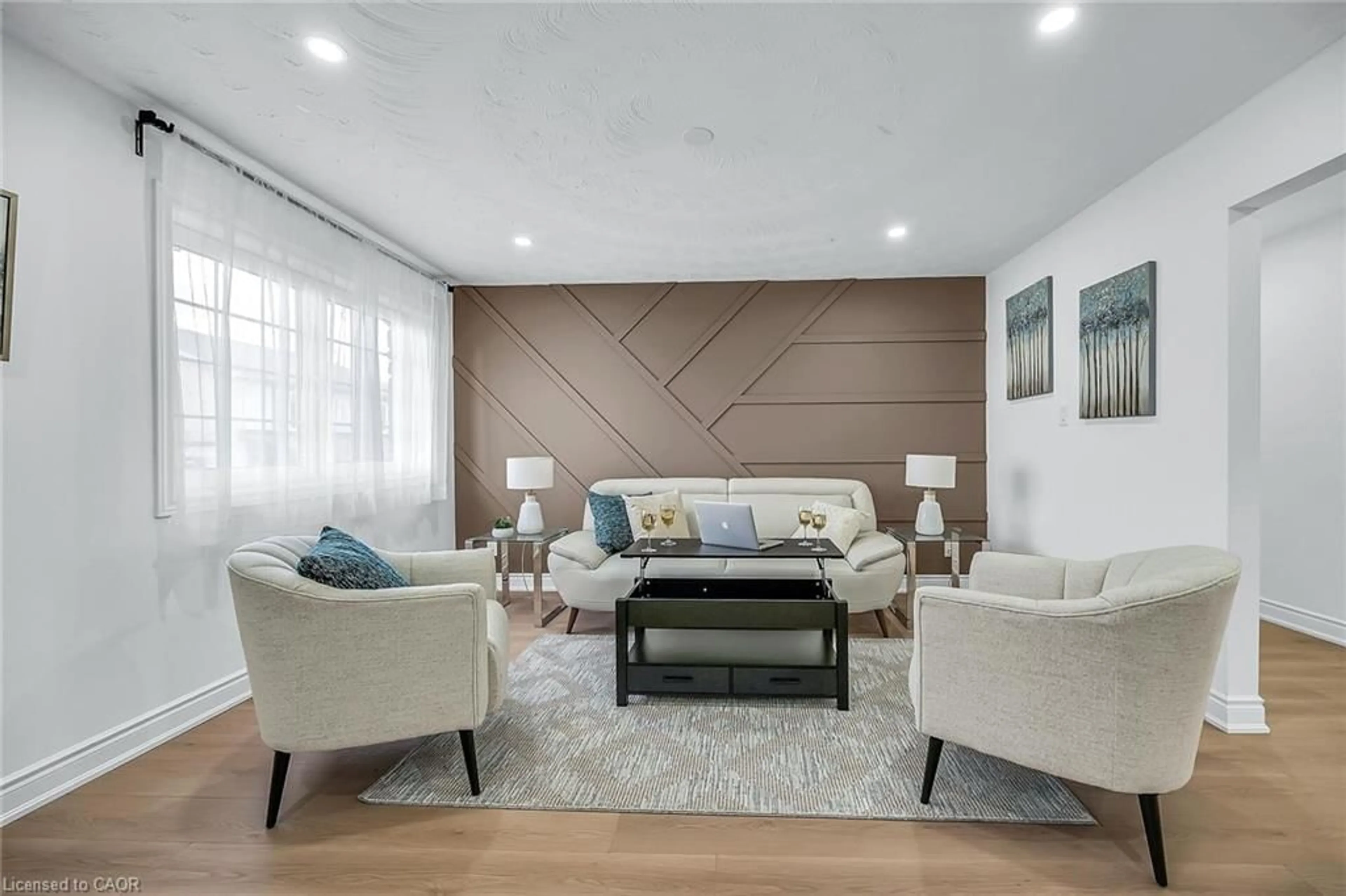 Living room with furniture, wood/laminate floor for 120 Second Rd, Stoney Creek Ontario L8J 3J2