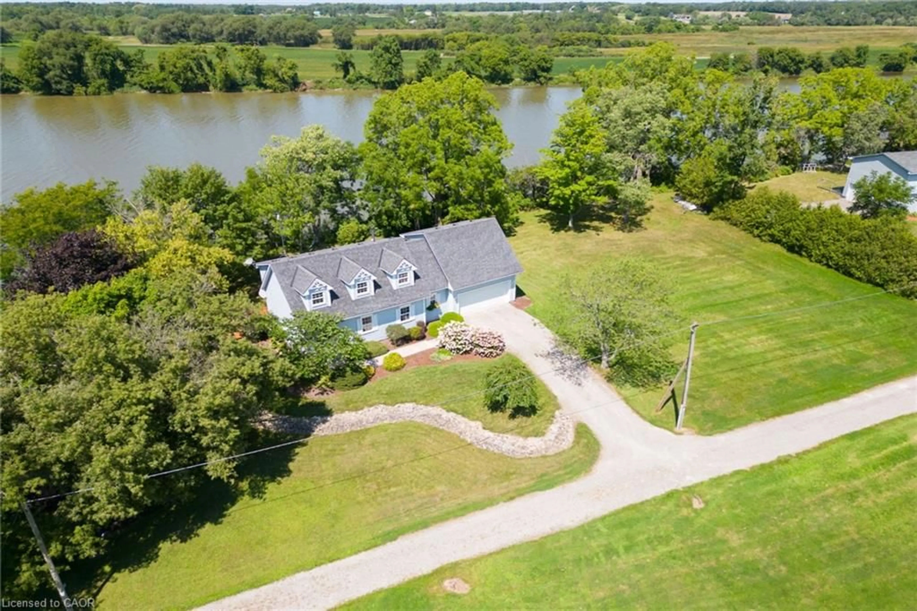 A pic from outside/outdoor area/front of a property/back of a property/a pic from drone, water/lake/river/ocean view for 1042 River Rd, Cayuga Ontario N0A 1E0
