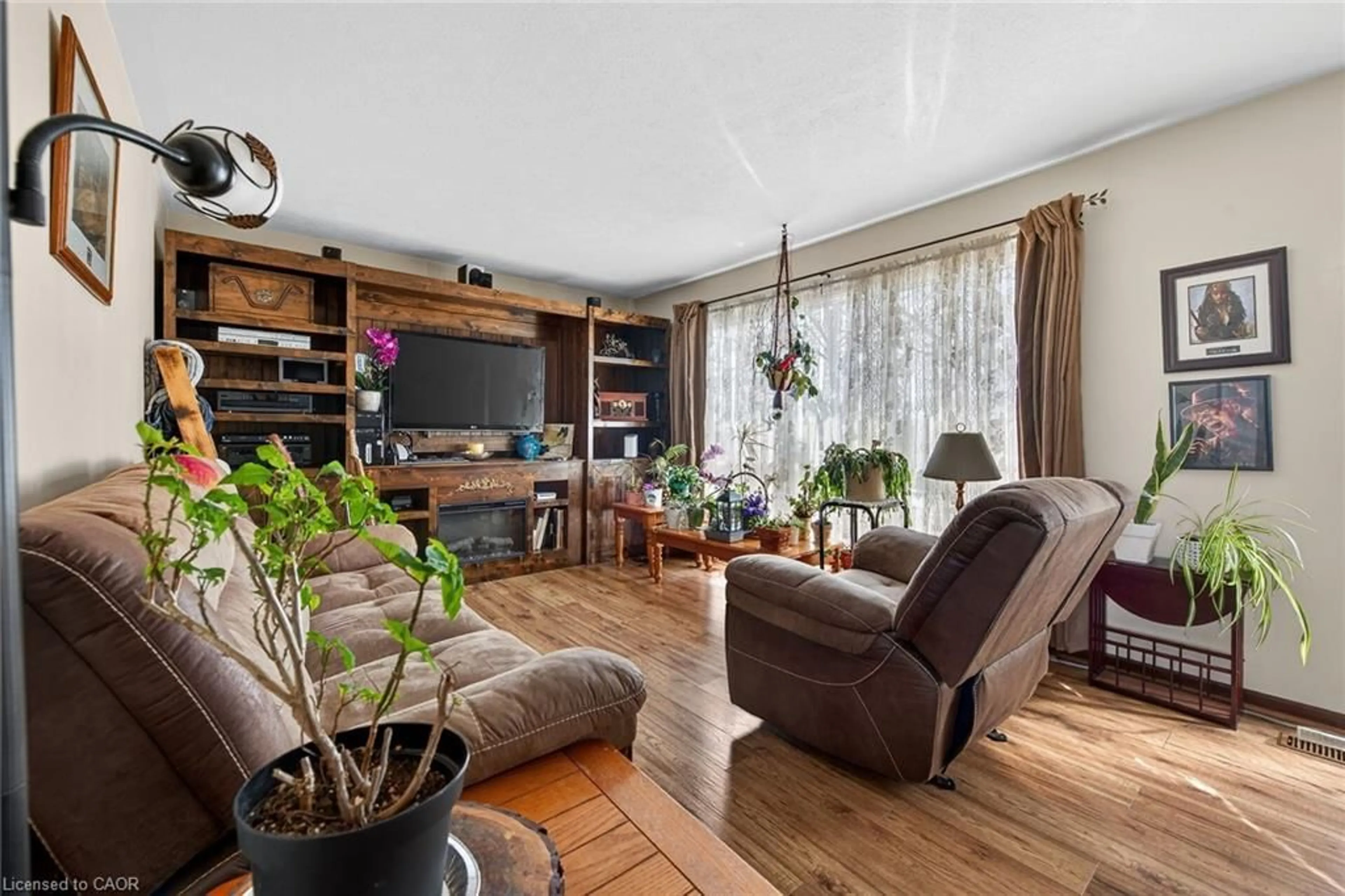 Living room with furniture, wood/laminate floor for 1057 Concession 4 Rd, Fisherville Ontario N0A 1G0