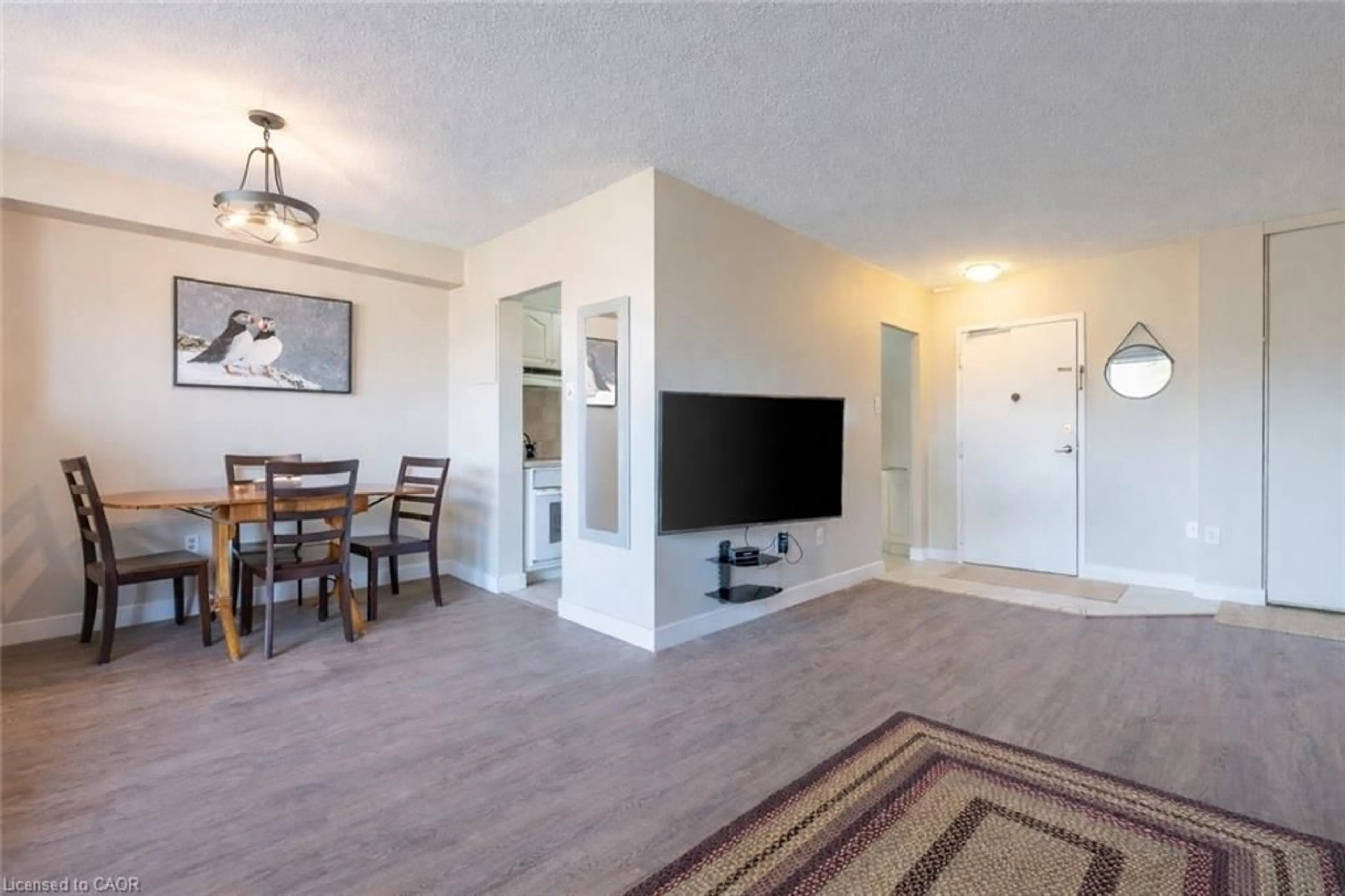 Living room with furniture, wood/laminate floor for 1968 Main St #909, Hamilton Ontario L8S 1J7