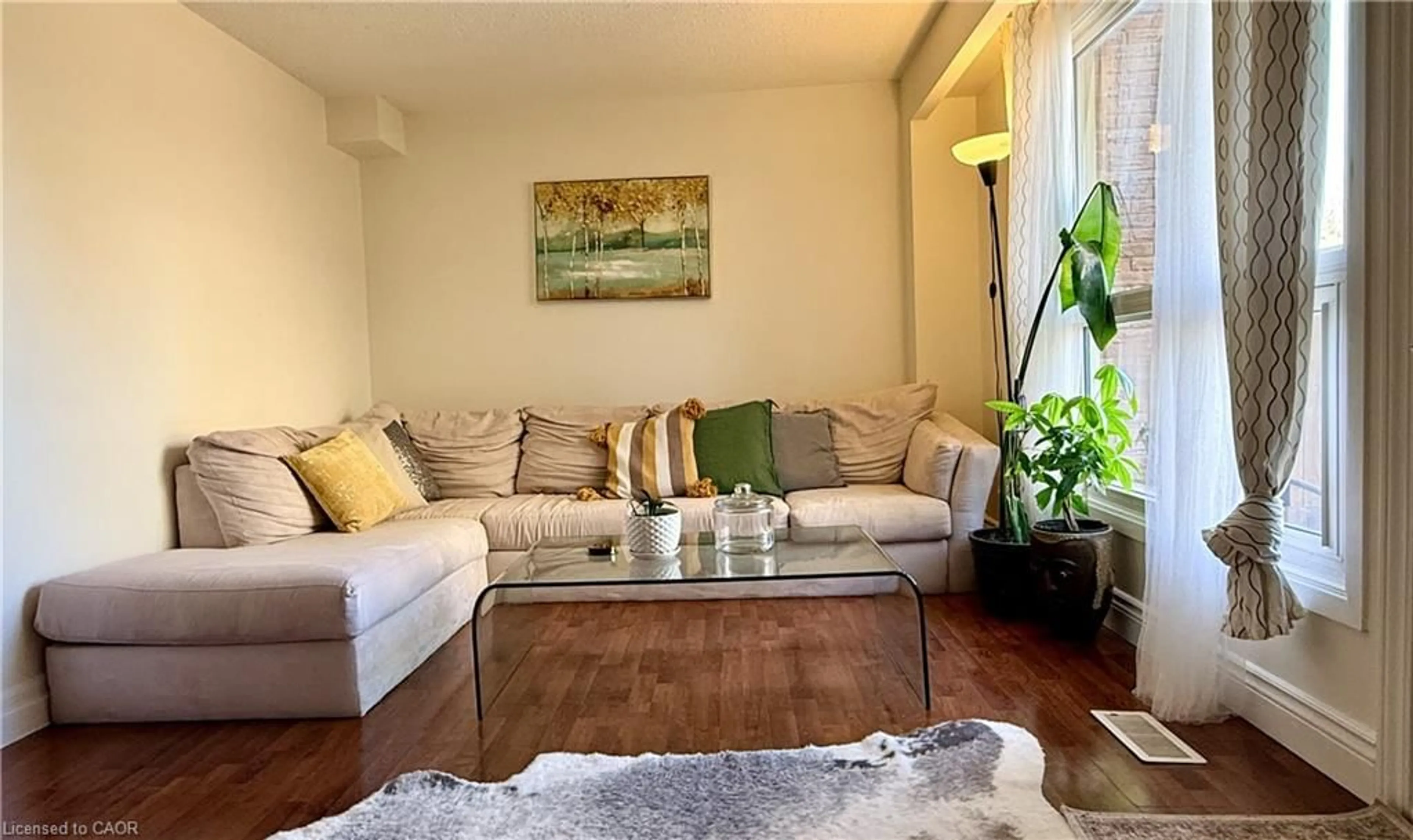 Living room with furniture, wood/laminate floor for 223 Pioneer Dr #F39, Kitchener Ontario N2P 1L9