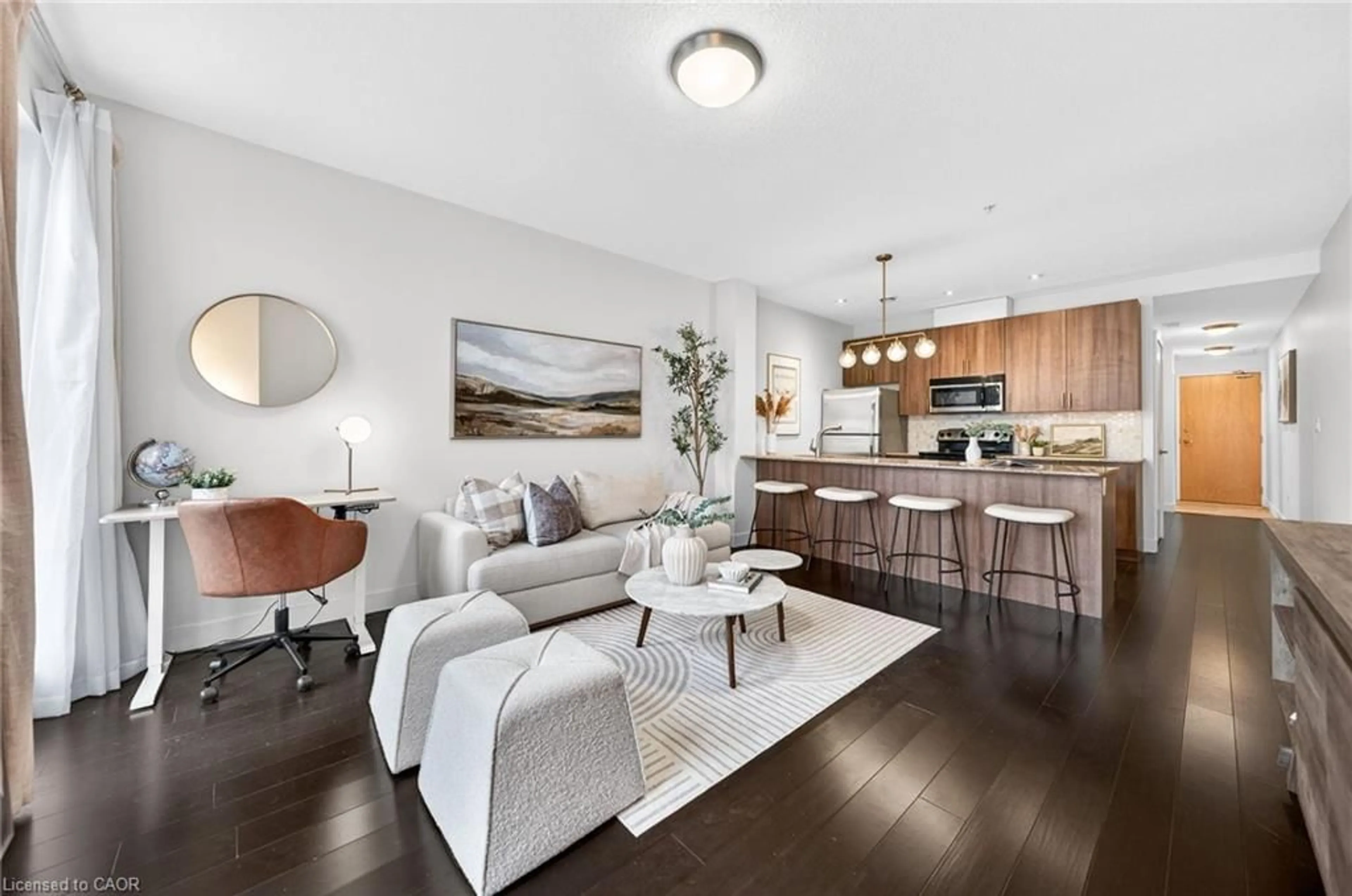 Living room with furniture, wood/laminate floor for 188 King St #207, Waterloo Ontario N2J 0C6