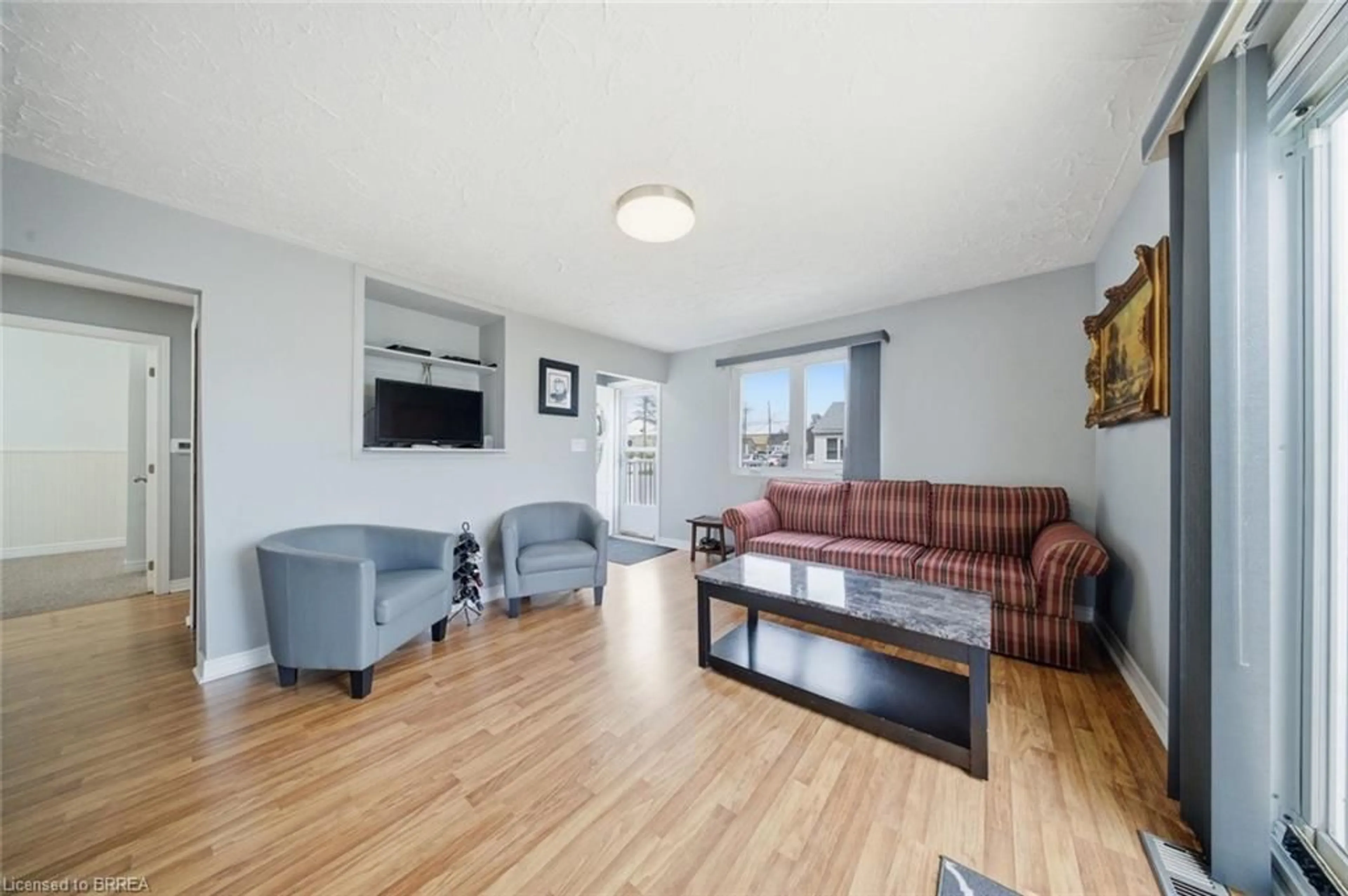 Living room with furniture, wood/laminate floor for 59 Lida St, Brantford Ontario N3S 2R7