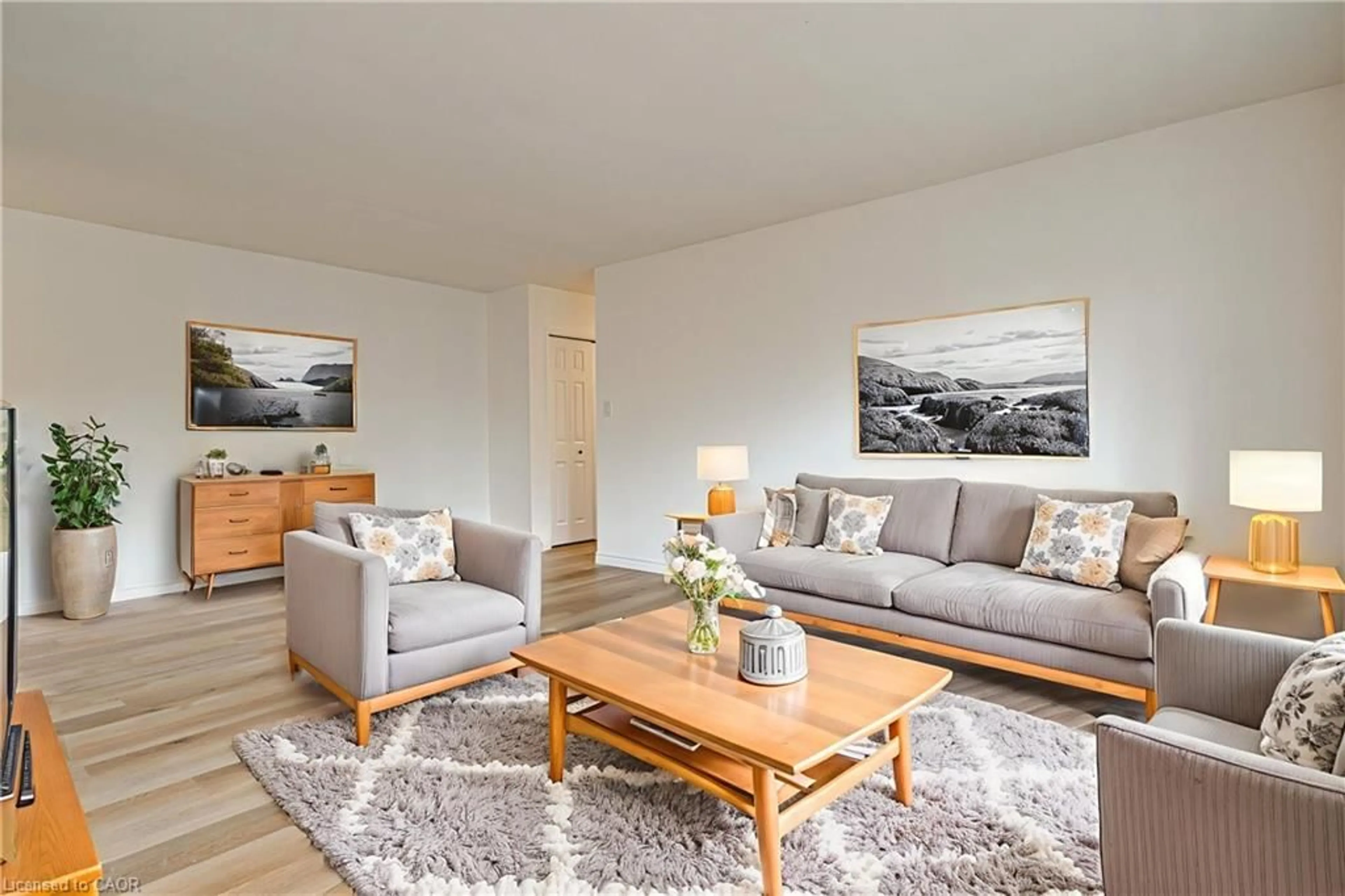 Living room with furniture, wood/laminate floor for 283 Fairway Rd #405, Kitchener Ontario N2A 2P1