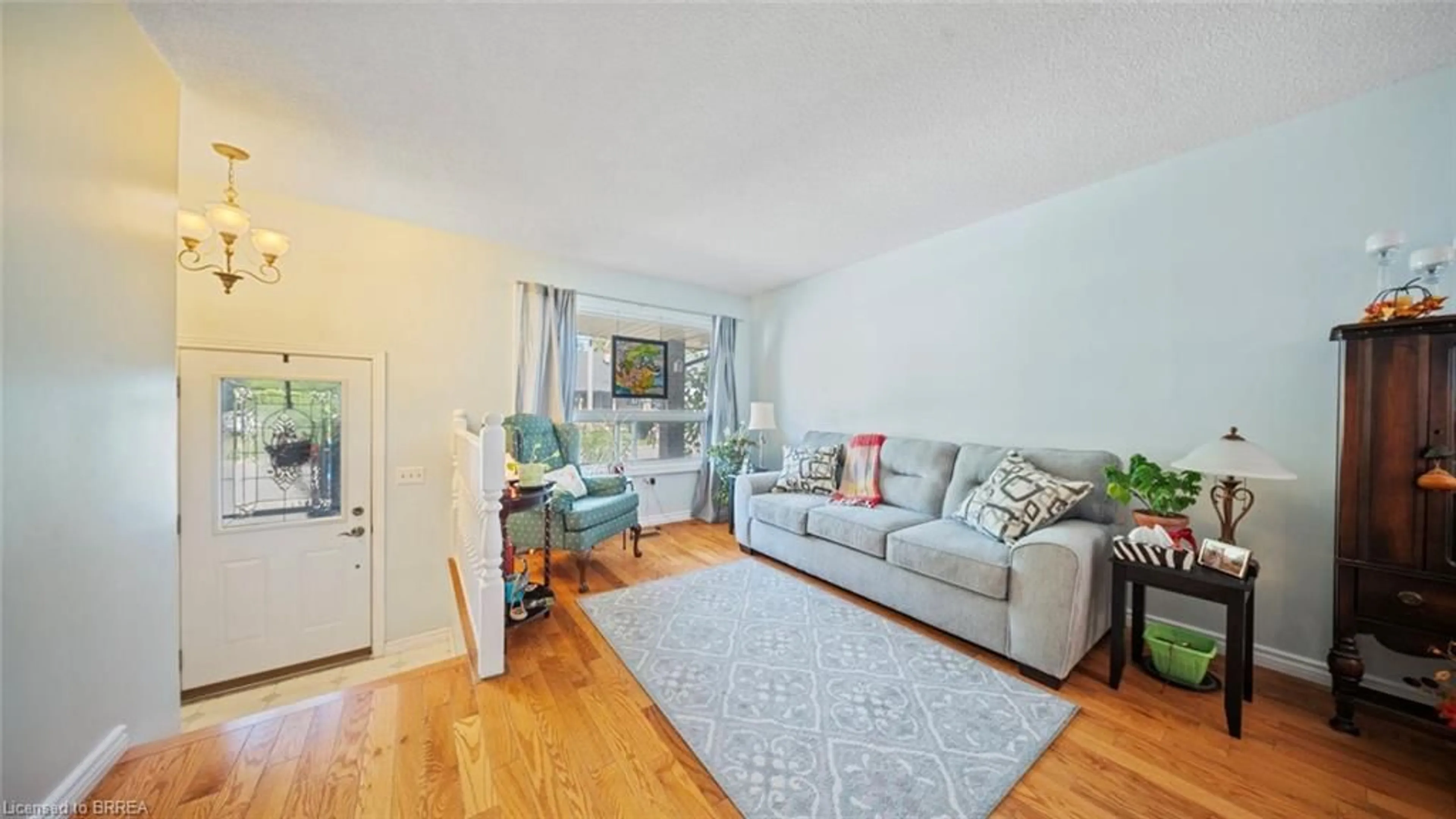 Living room with furniture, wood/laminate floor for 6442 Taylor St, Niagara Falls Ontario L2G 2G1