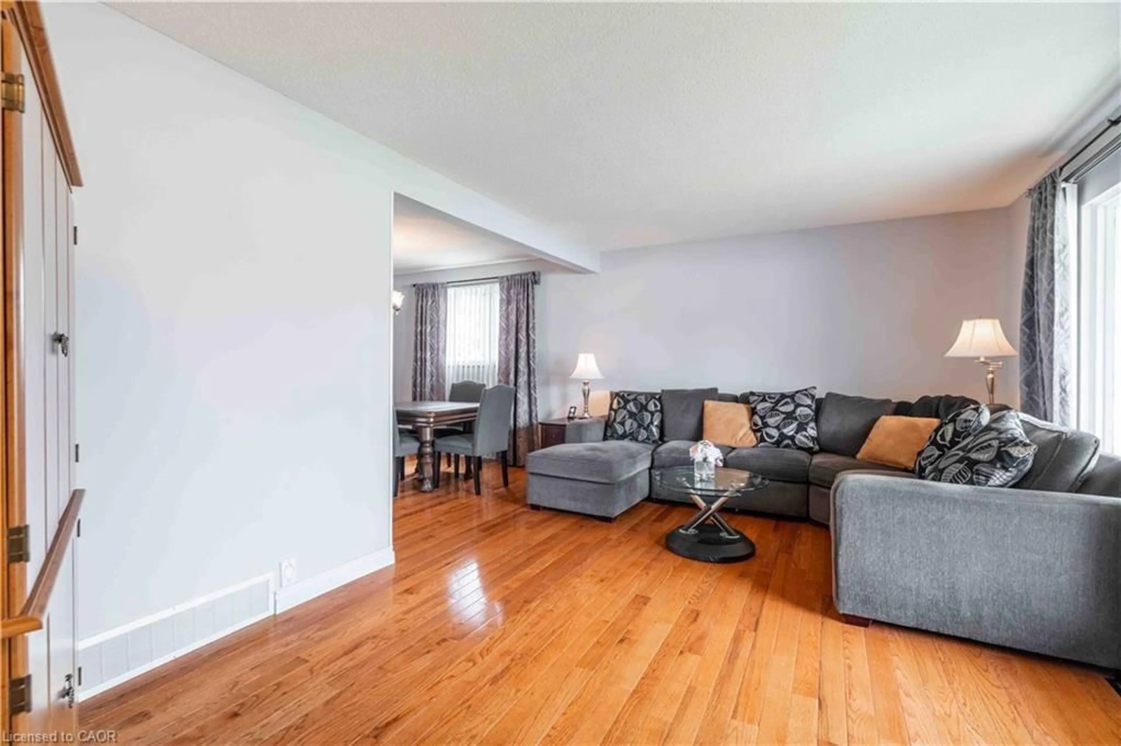 Living room with furniture, wood/laminate floor for 519 Brigadoon Dr, Hamilton Ontario L9C 6C9