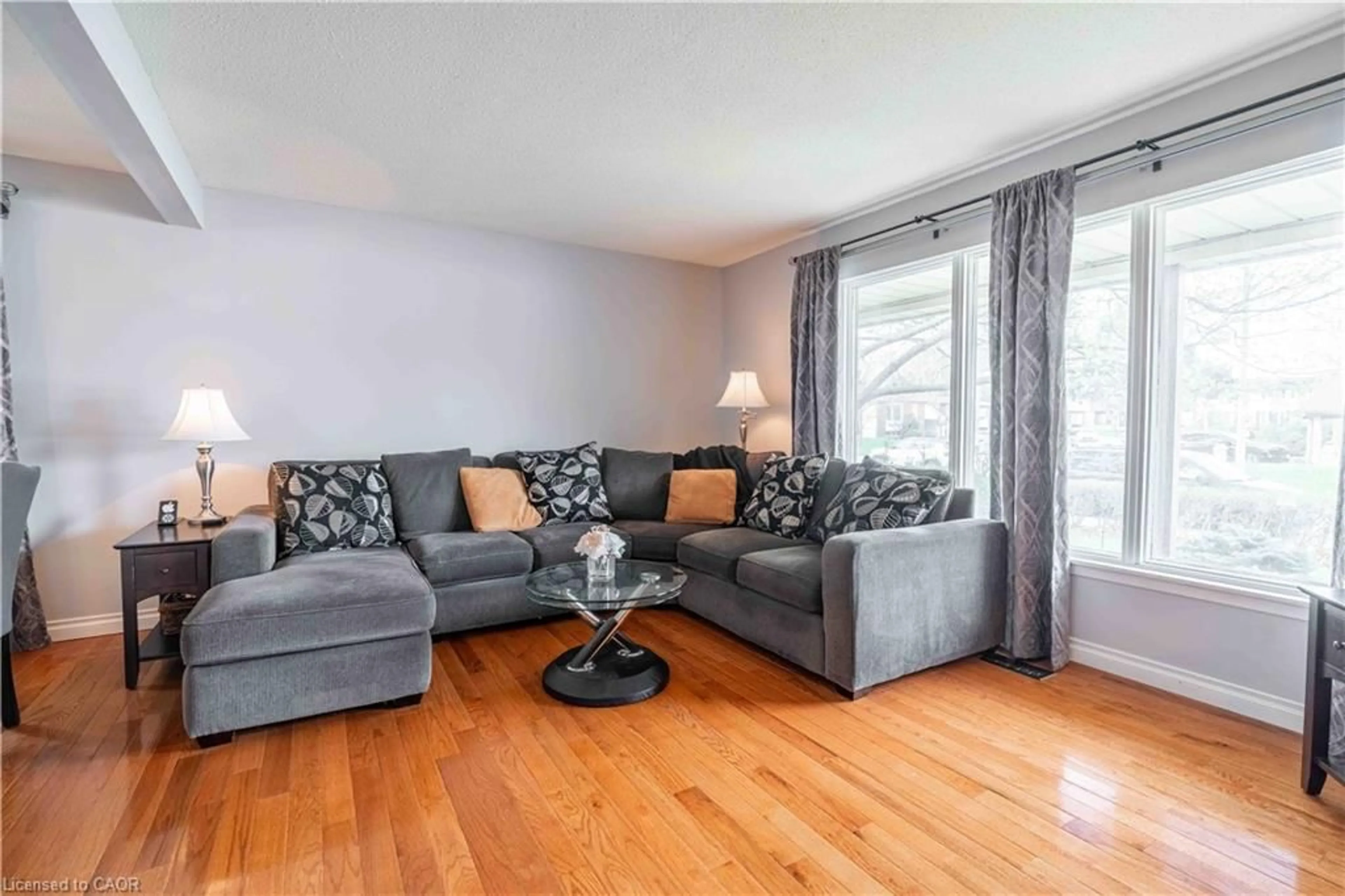 Living room with furniture, wood/laminate floor for 519 Brigadoon Dr, Hamilton Ontario L9C 6C9