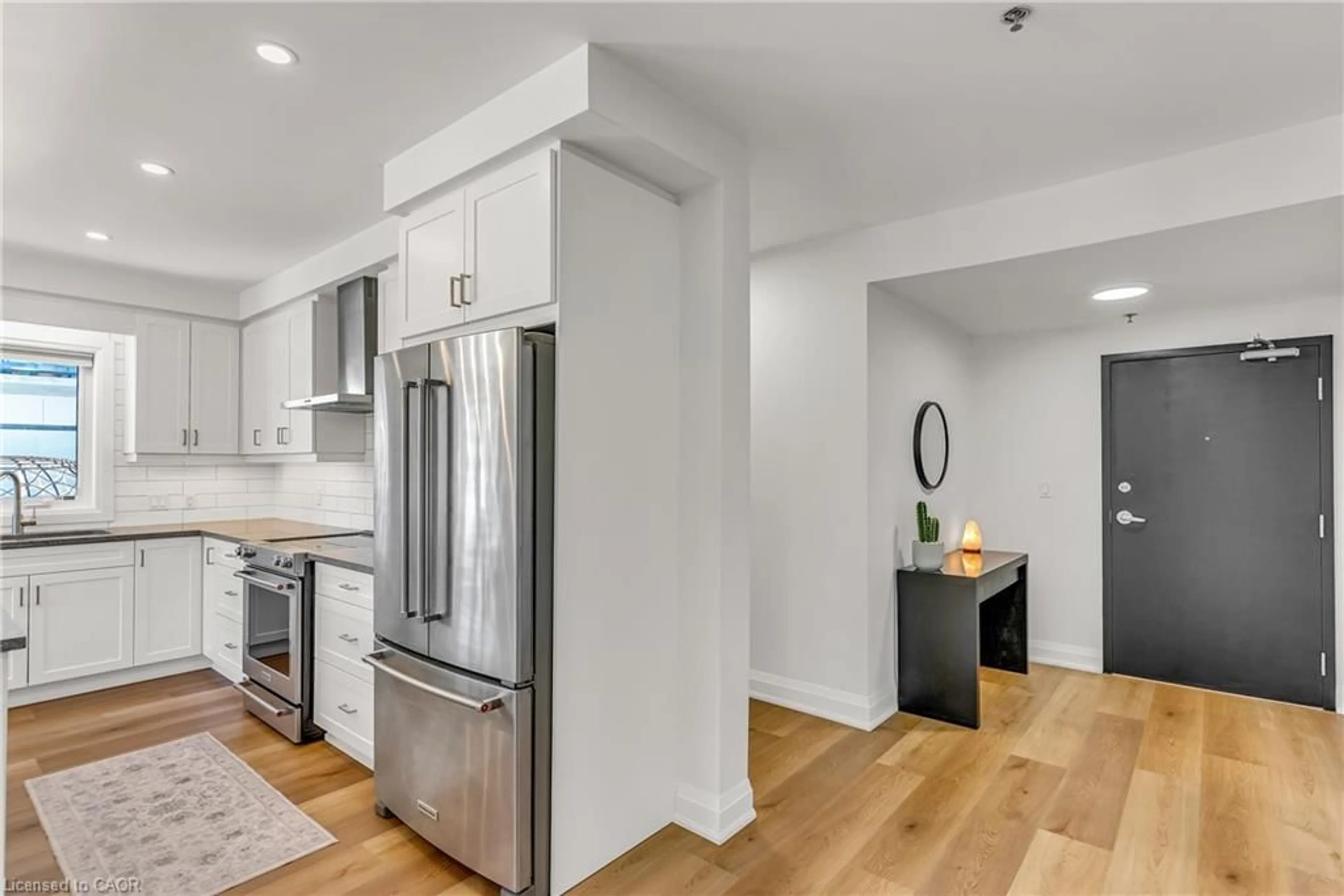 Open concept kitchen, wood/laminate floor for 247 Grey Silo Rd #102, Waterloo Ontario N2K 0G7