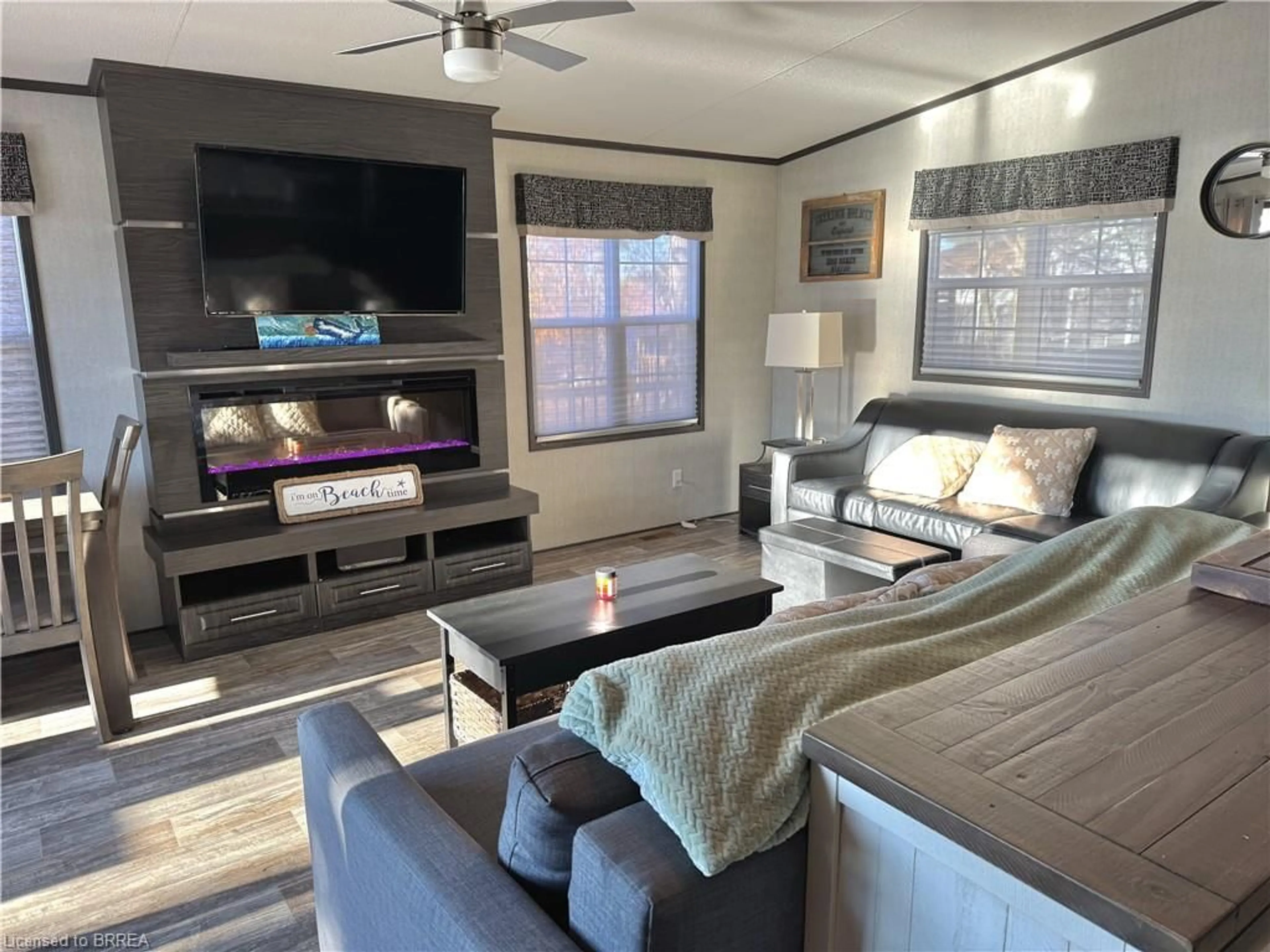 Living room with furniture, wood/laminate floor for 1336 South Morrison Lake Rd #23 Riverside, Kilworthy Ontario P0E 1G0