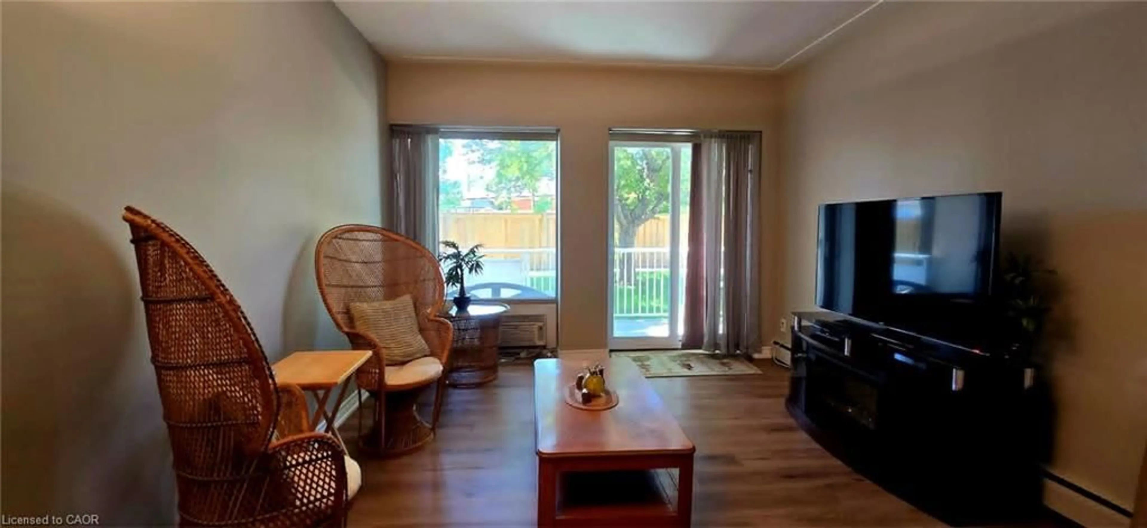Living room with furniture, wood/laminate floor for 10 Woodman Dr #108, Hamilton Ontario L8K 4E1