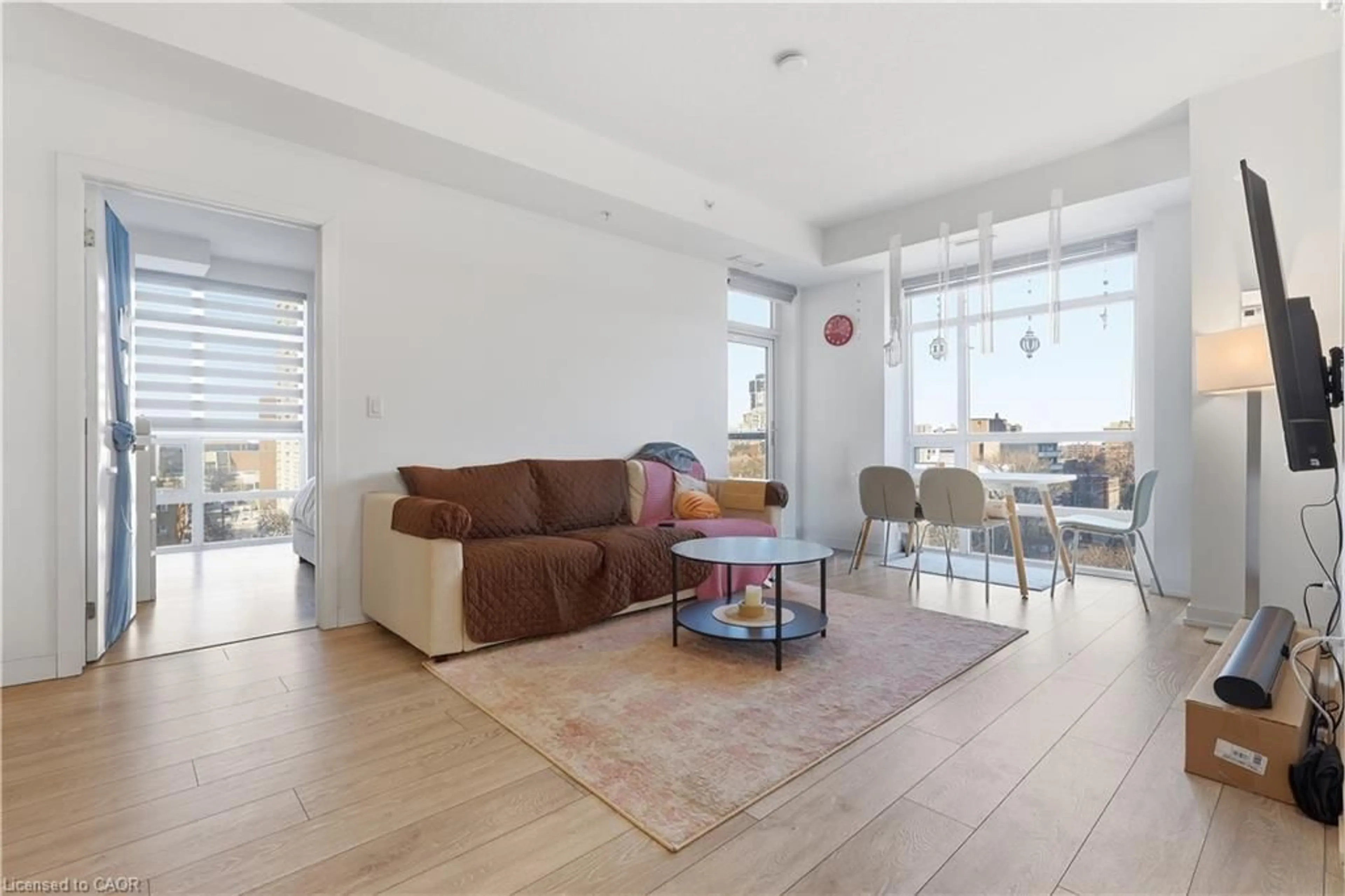 Living room with furniture, wood/laminate floor for 81 Robinson St #807, Hamilton Ontario L8P 0C2