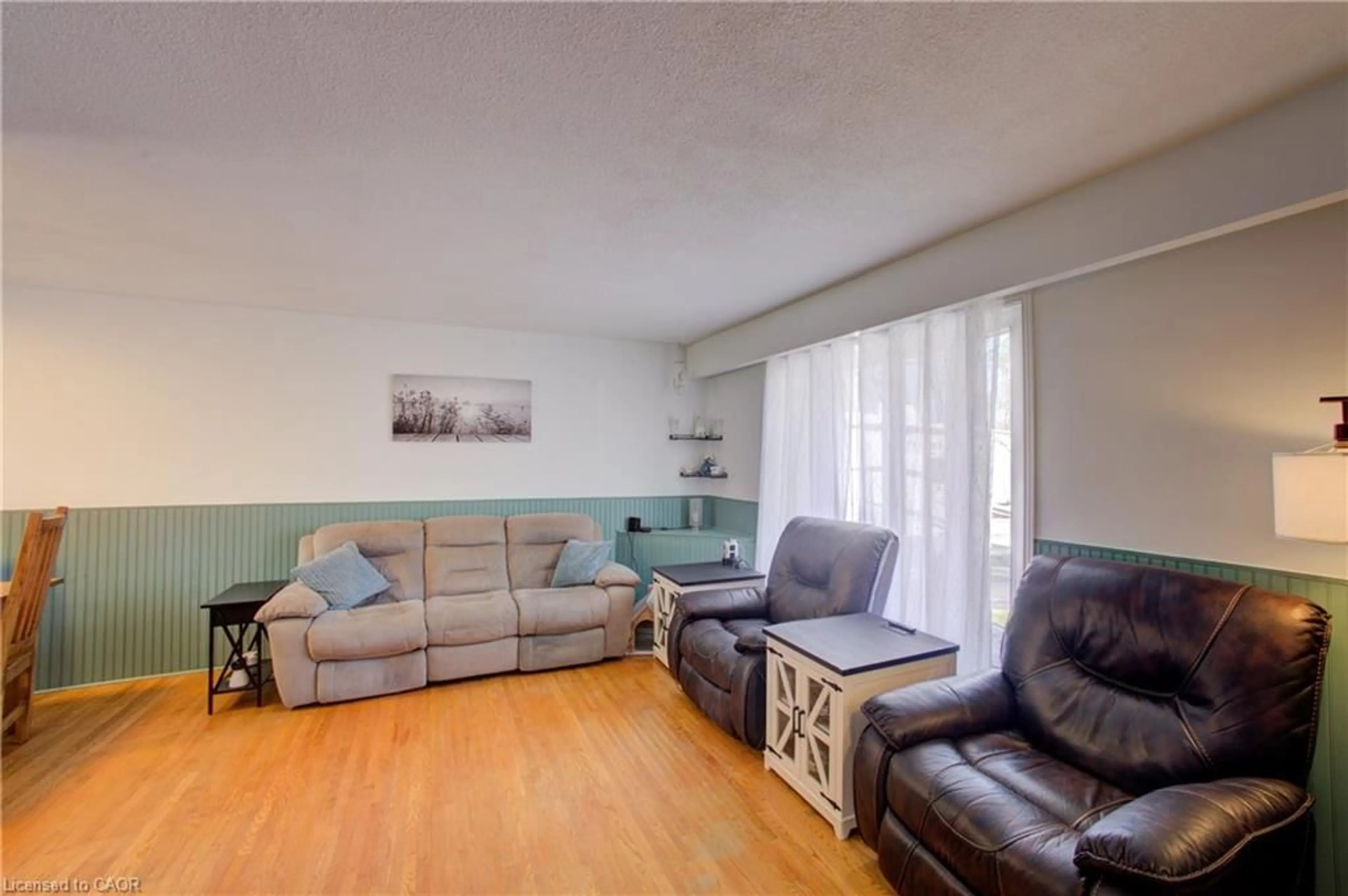 Living room with furniture, wood/laminate floor for 354 Falconer St, Saugeen Shores Ontario N0H 2C2