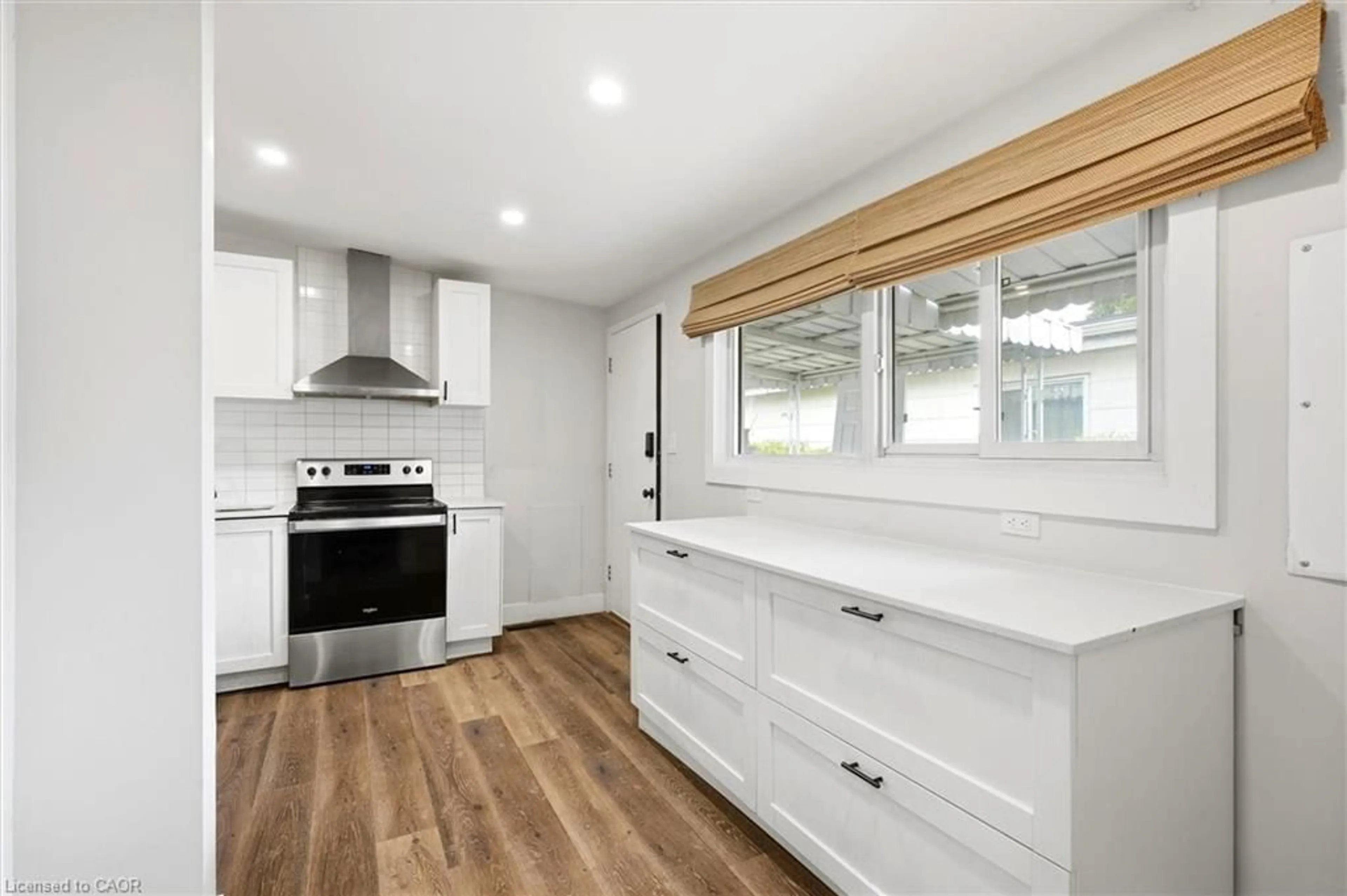 Open concept kitchen, wood/laminate floor for 16 Ronaldshay Ave, Hamilton Ontario L9A 3B1