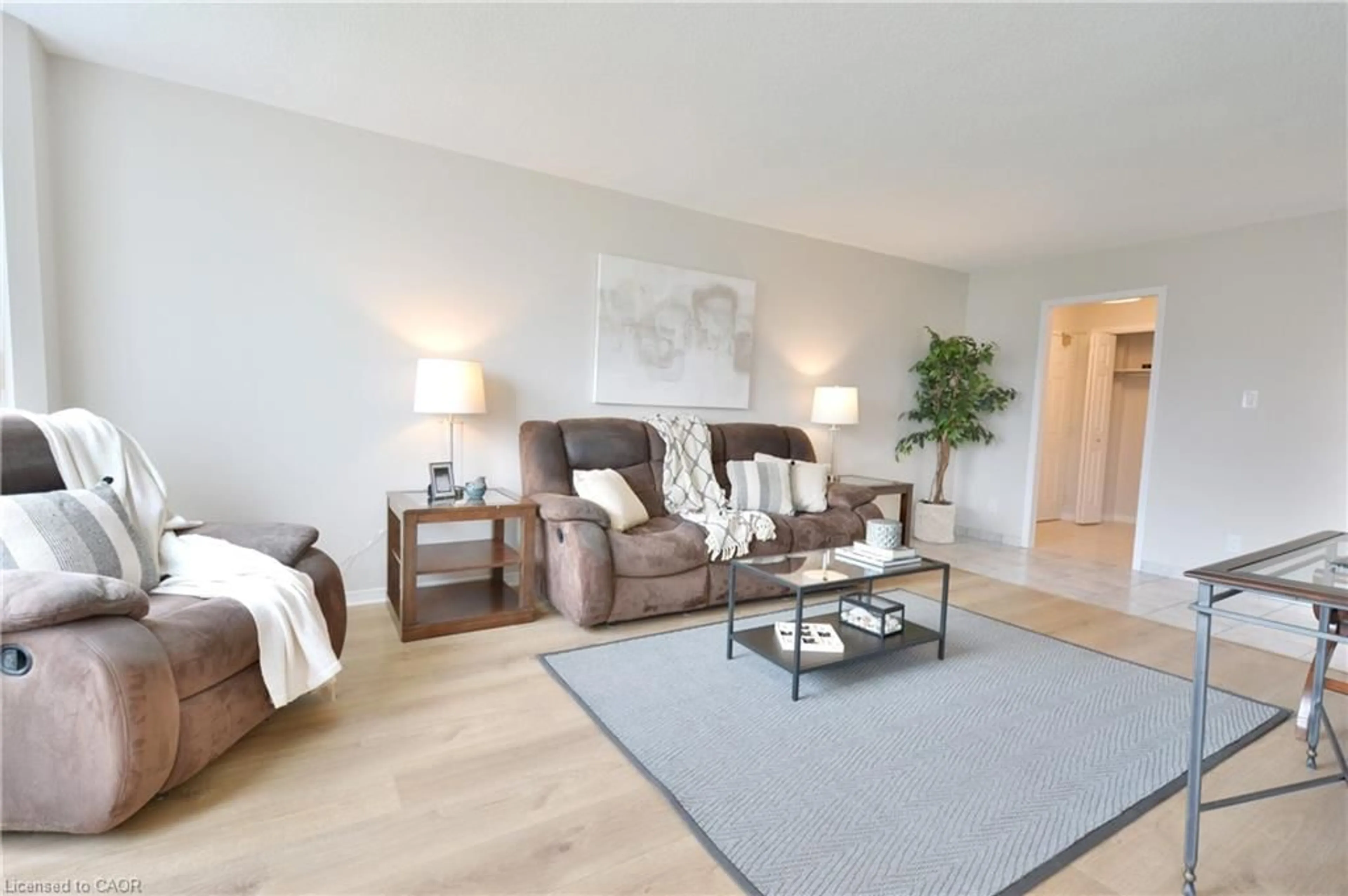 Living room with furniture, wood/laminate floor for 180 Limeridge Rd #307, Hamilton Ontario L9C 7C7