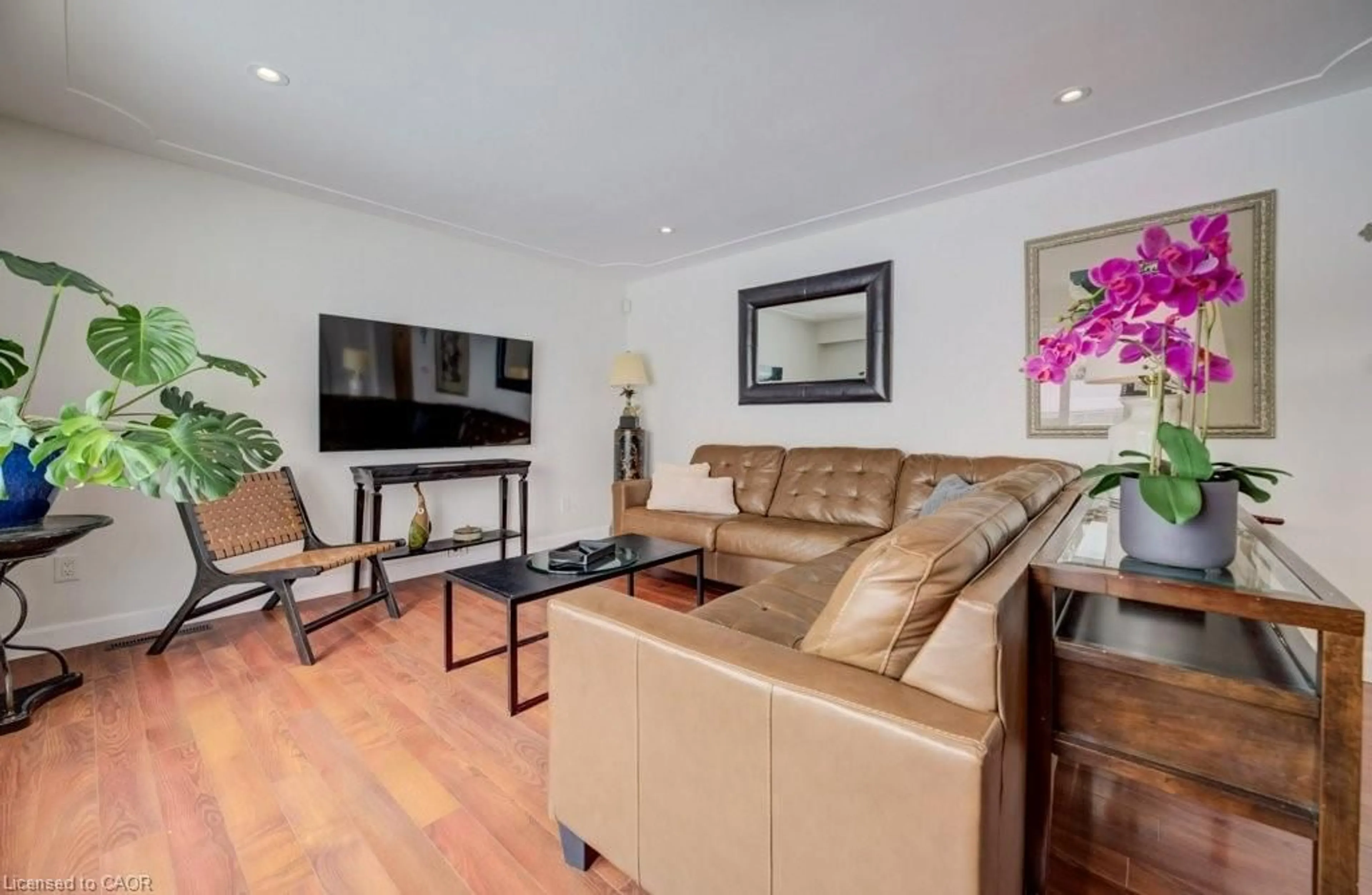 Living room with furniture, wood/laminate floor for 185 Miller St, Mount Forest Ontario N0G 2L3