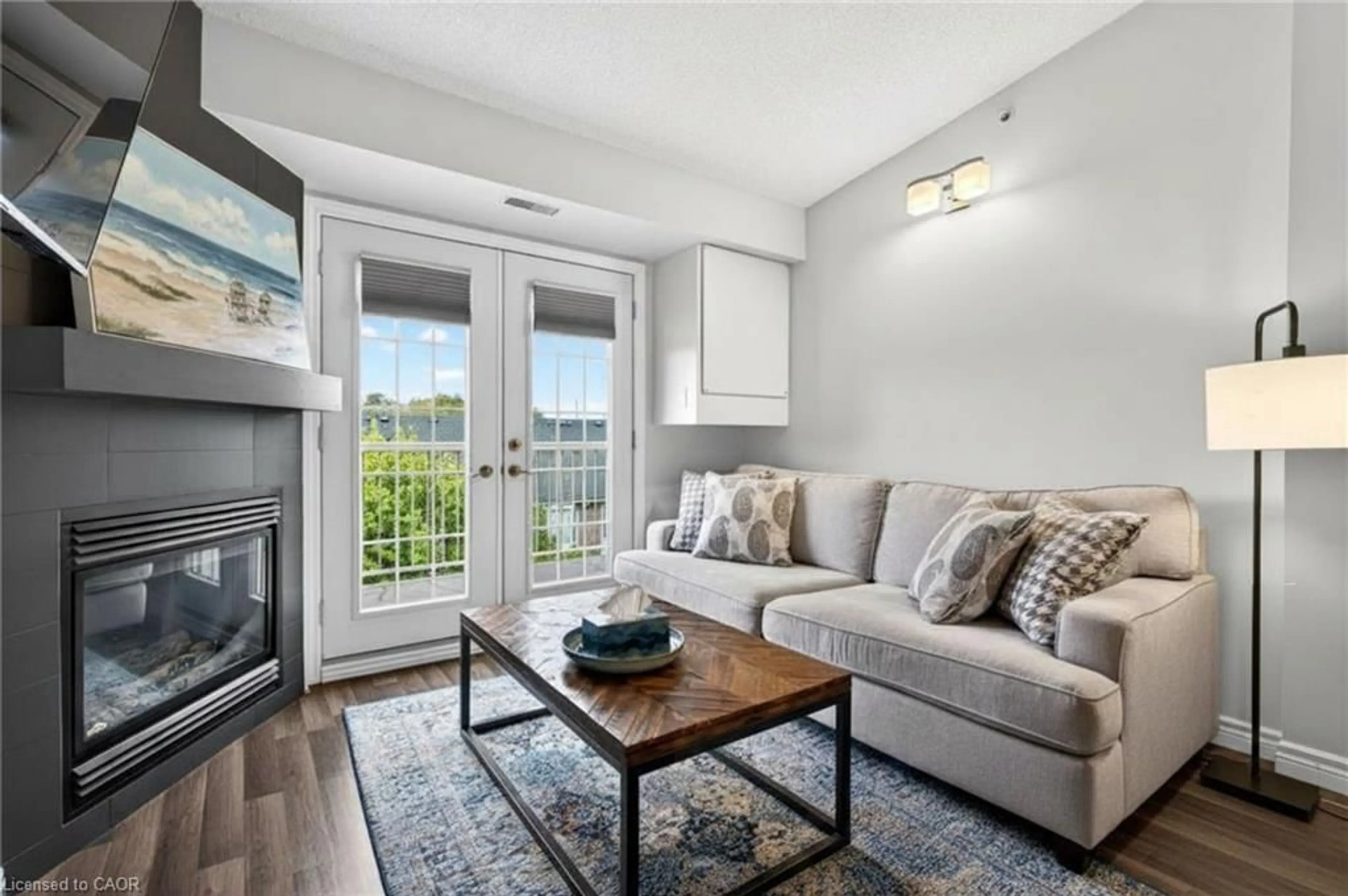 Living room with furniture, wood/laminate floor for 1820 Walker's Line #403, Burlington Ontario L7M 4V4