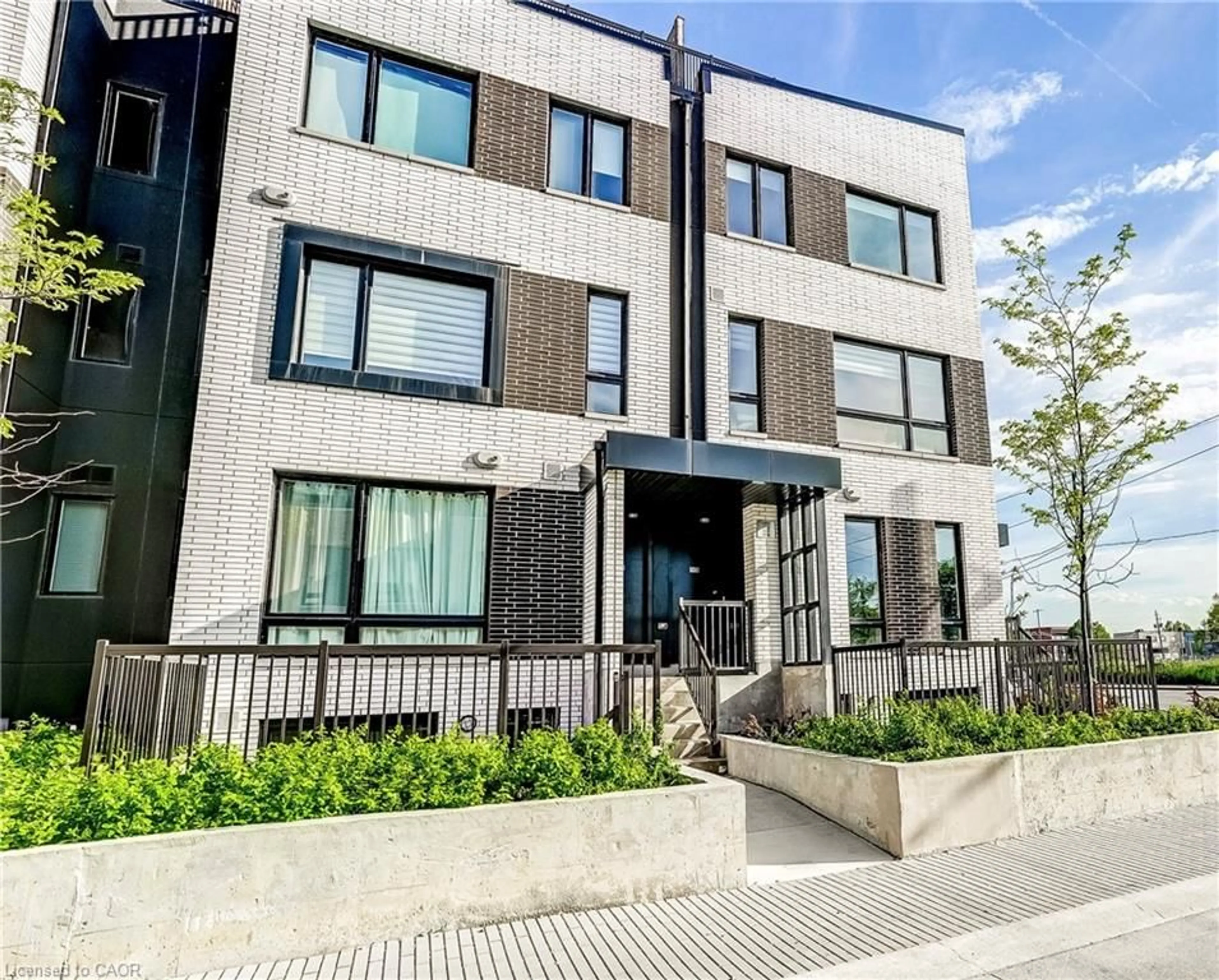 Home with brick exterior material, street for 40 Ed Clark Gardens Gdns #TH16, Toronto Ontario M6N 0B5