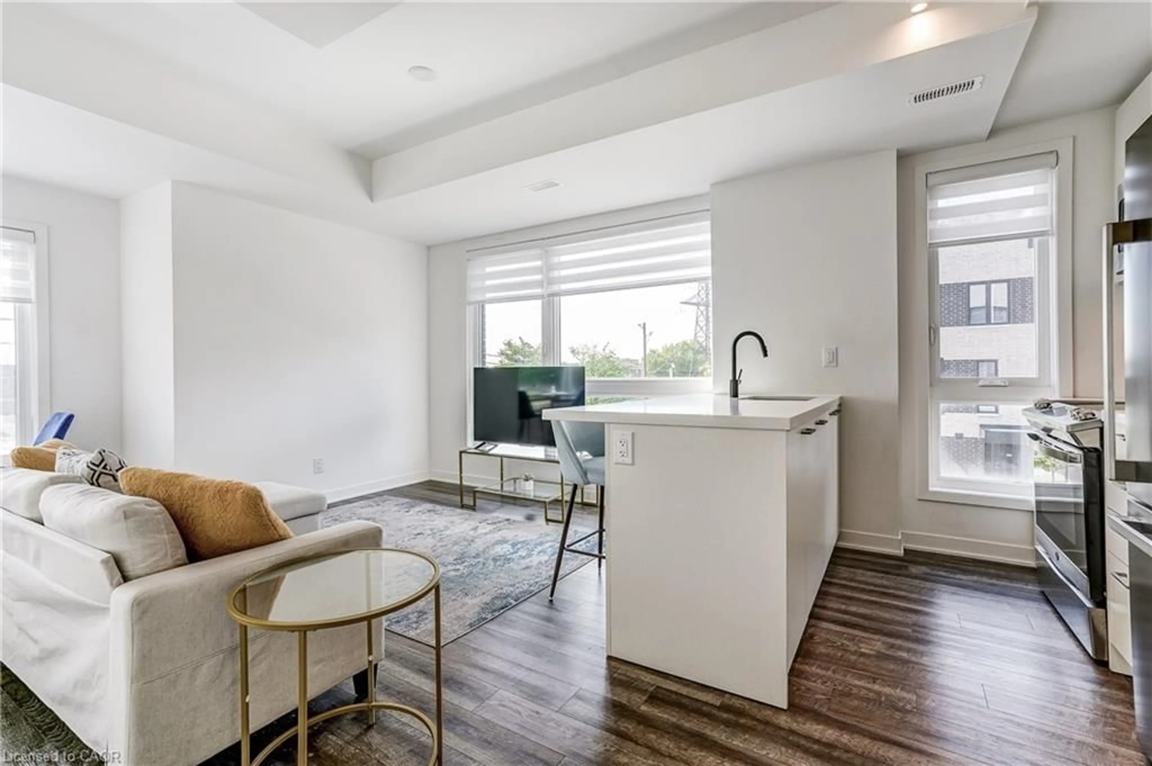 Open concept kitchen, wood/laminate floor for 40 Ed Clark Gardens Gdns #TH16, Toronto Ontario M6N 0B5