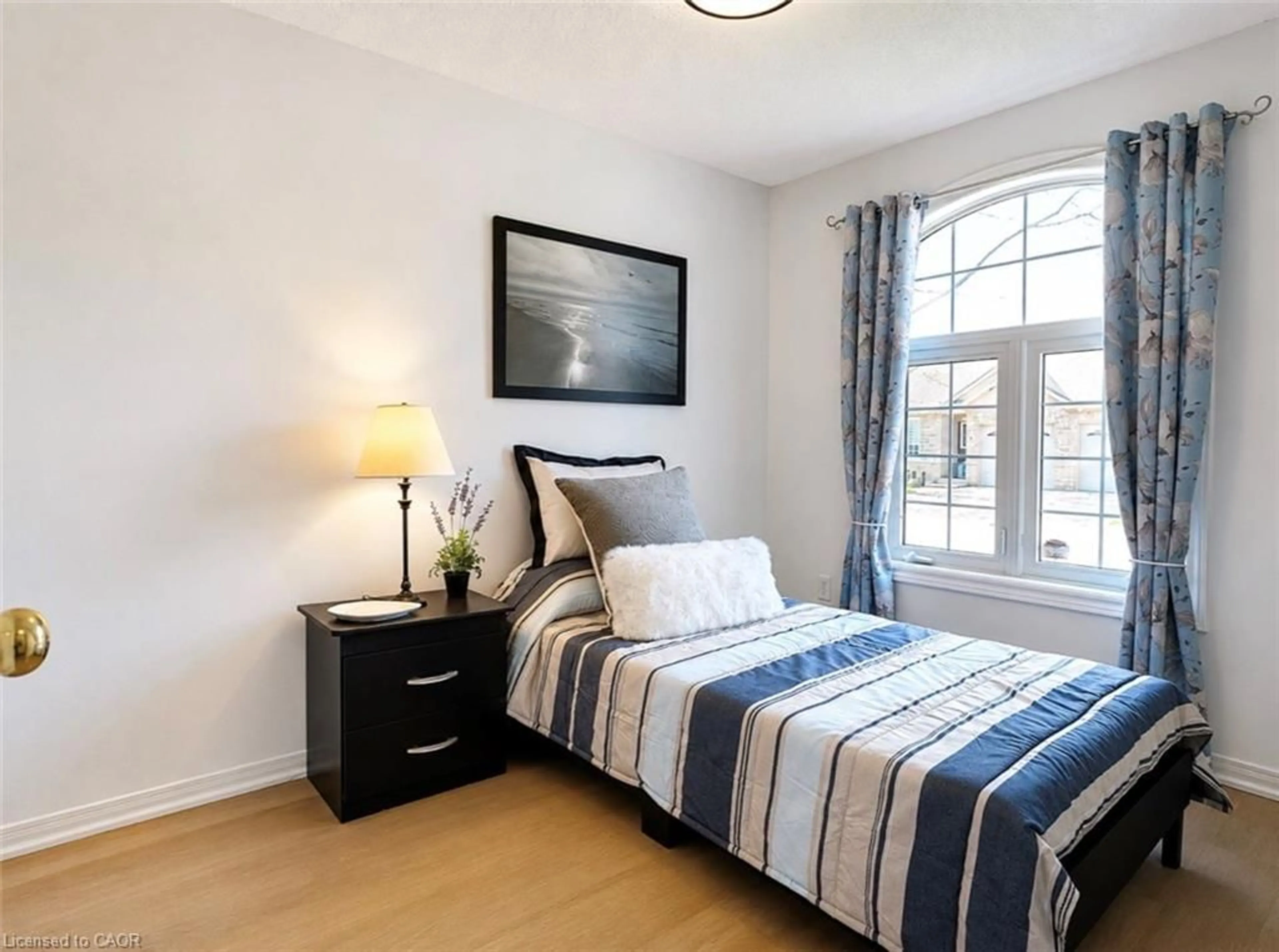 Bedroom with bed, wood/laminate floor for 751 Rymal Rd #8, Hamilton Ontario L9B 2Y3