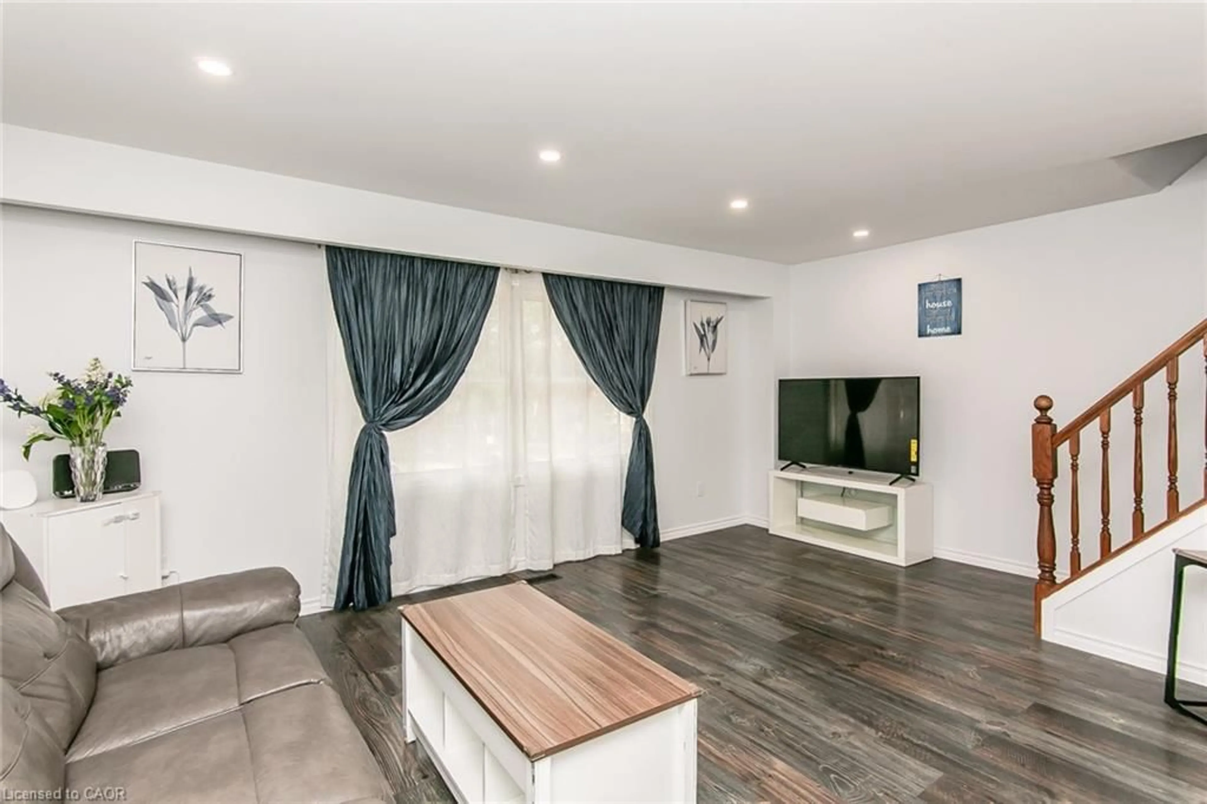 Living room with furniture, wood/laminate floor for 223 Pioneer Dr #J62, Kitchener Ontario N2P 1L9