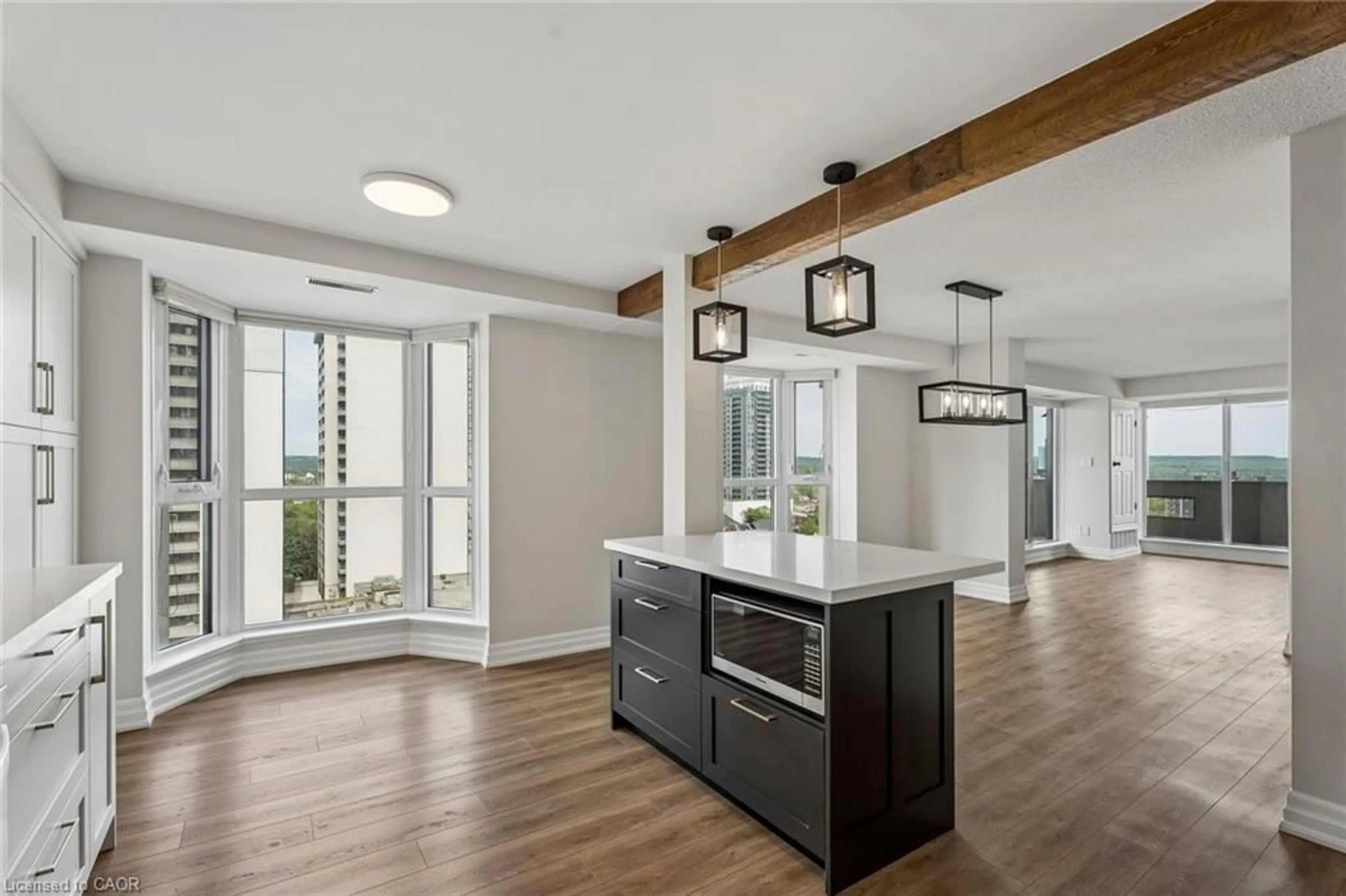 Open concept kitchen, wood/laminate floor for 67 Caroline St #1304, Hamilton Ontario L8P 3K6