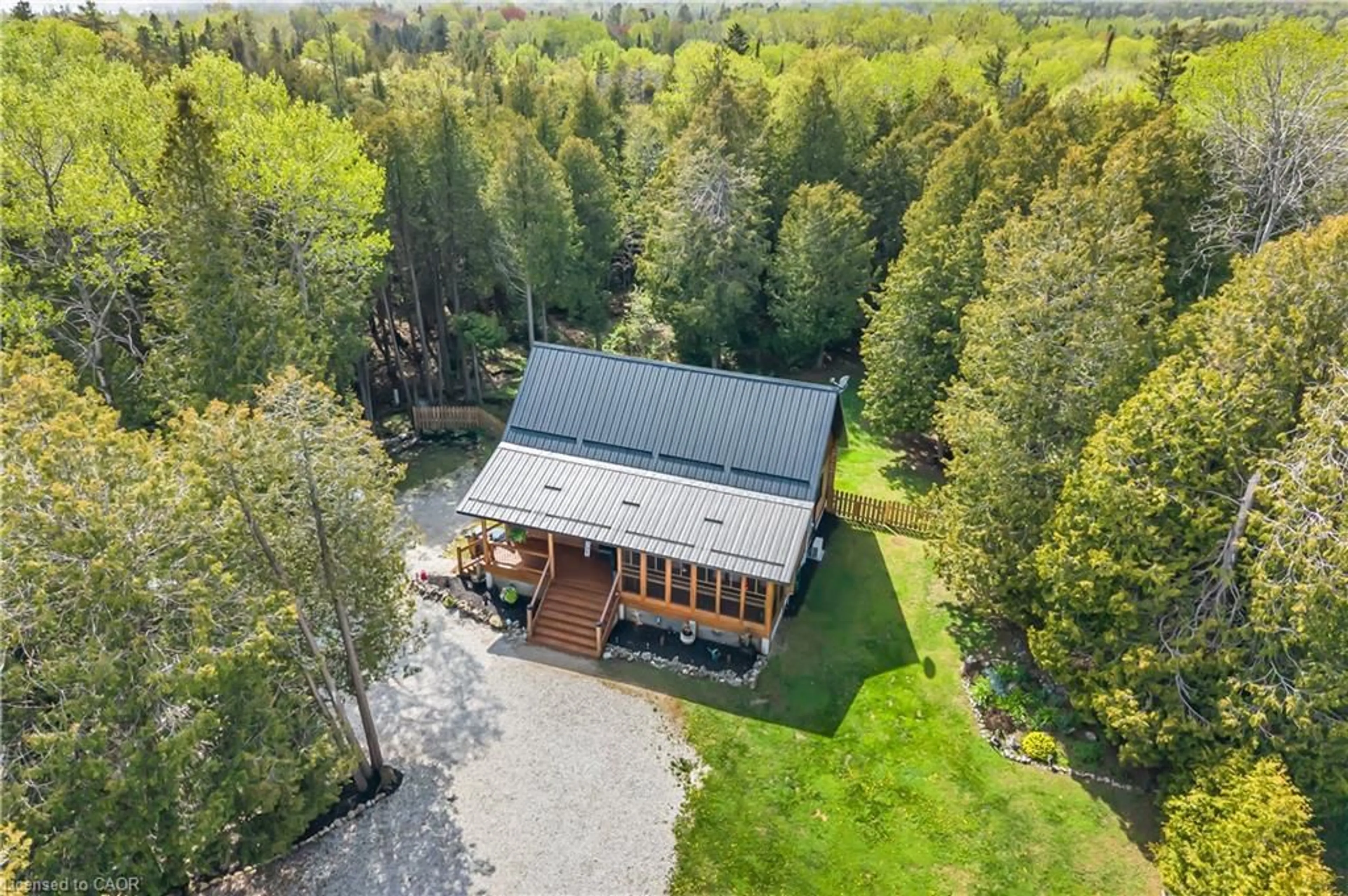 A pic from outside/outdoor area/front of a property/back of a property/a pic from drone, forest/trees view for 595 Stokes Bay Rd, Lions Head Ontario N0H 1W0