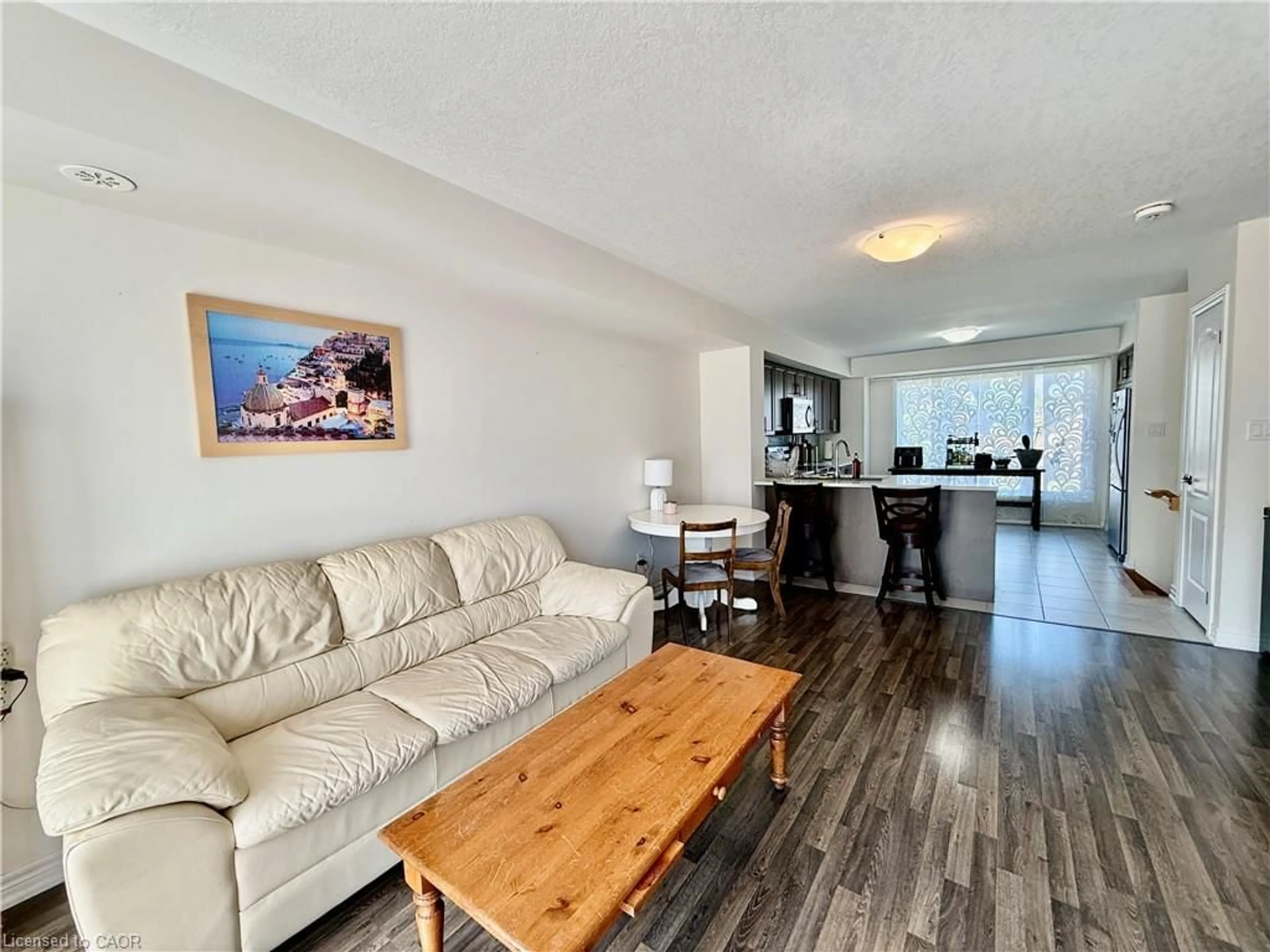 Living room with furniture, wood/laminate floor for 146 Watson Pky, Guelph Ontario N1E 0P6