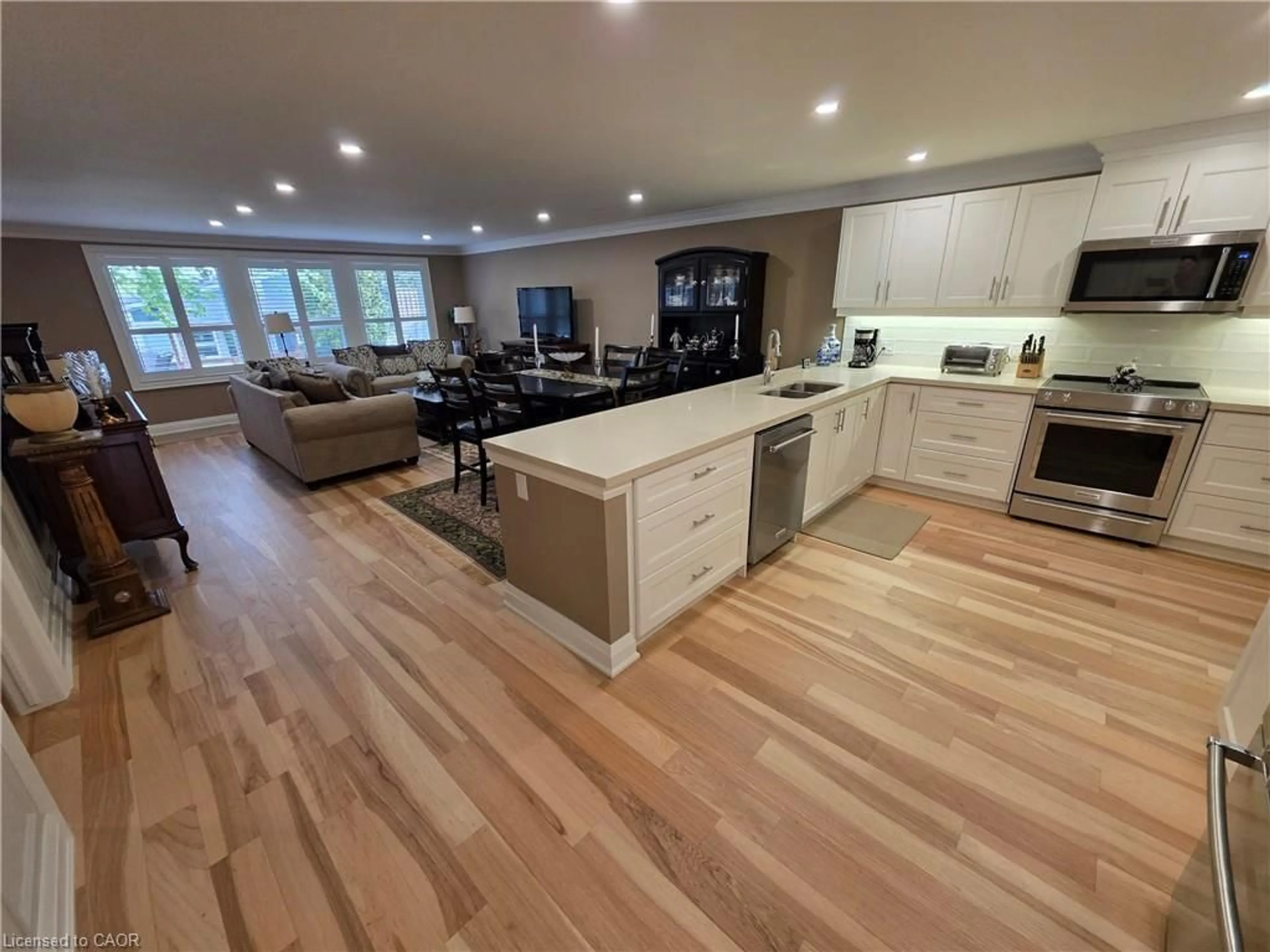 Open concept kitchen, wood/laminate floor for 10 Archdeacon Clark Trail, Hamilton Ontario L9B 2M2