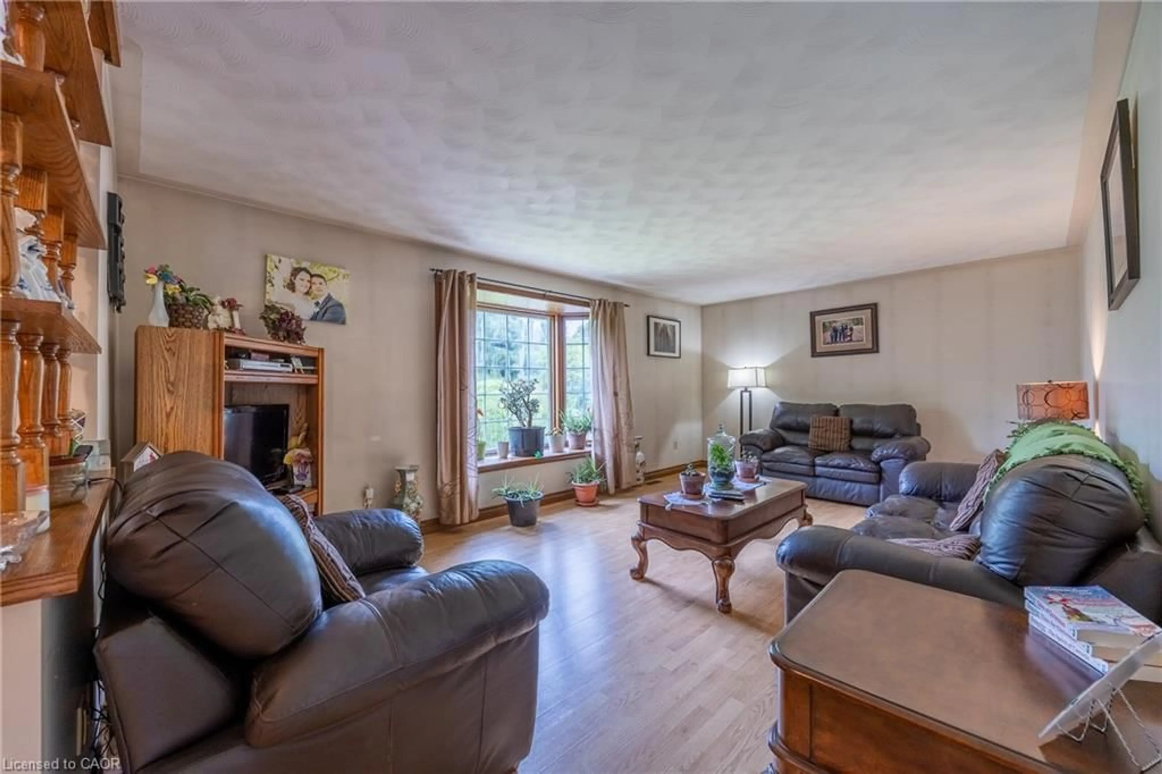 Living room with furniture, wood/laminate floor for 1841 Turkey Point Rd, Charlotteville Ontario N3Y 4J9