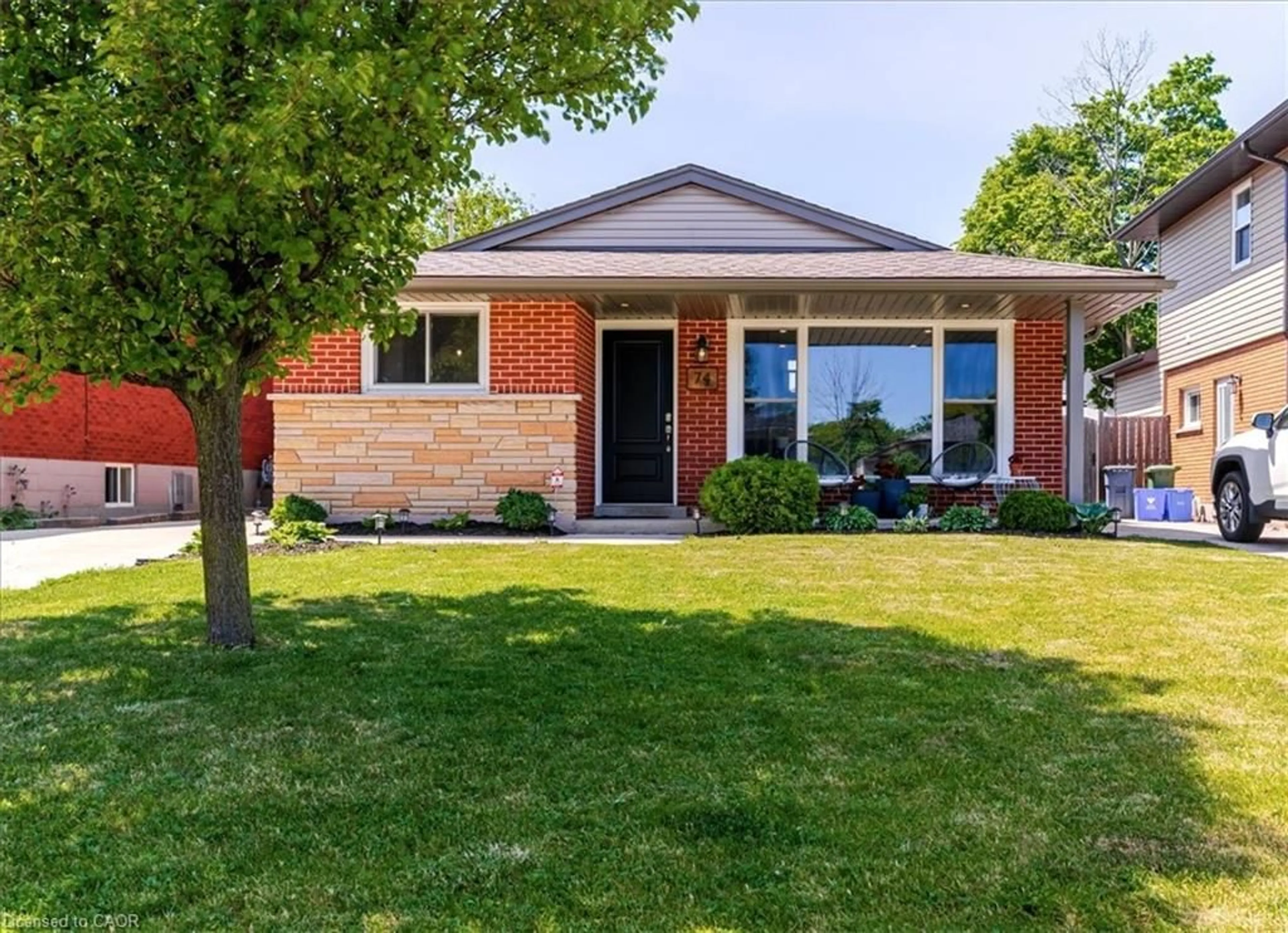 Home with brick exterior material, street for 74 Greeningdon Dr, Hamilton Ontario L9A 3A7