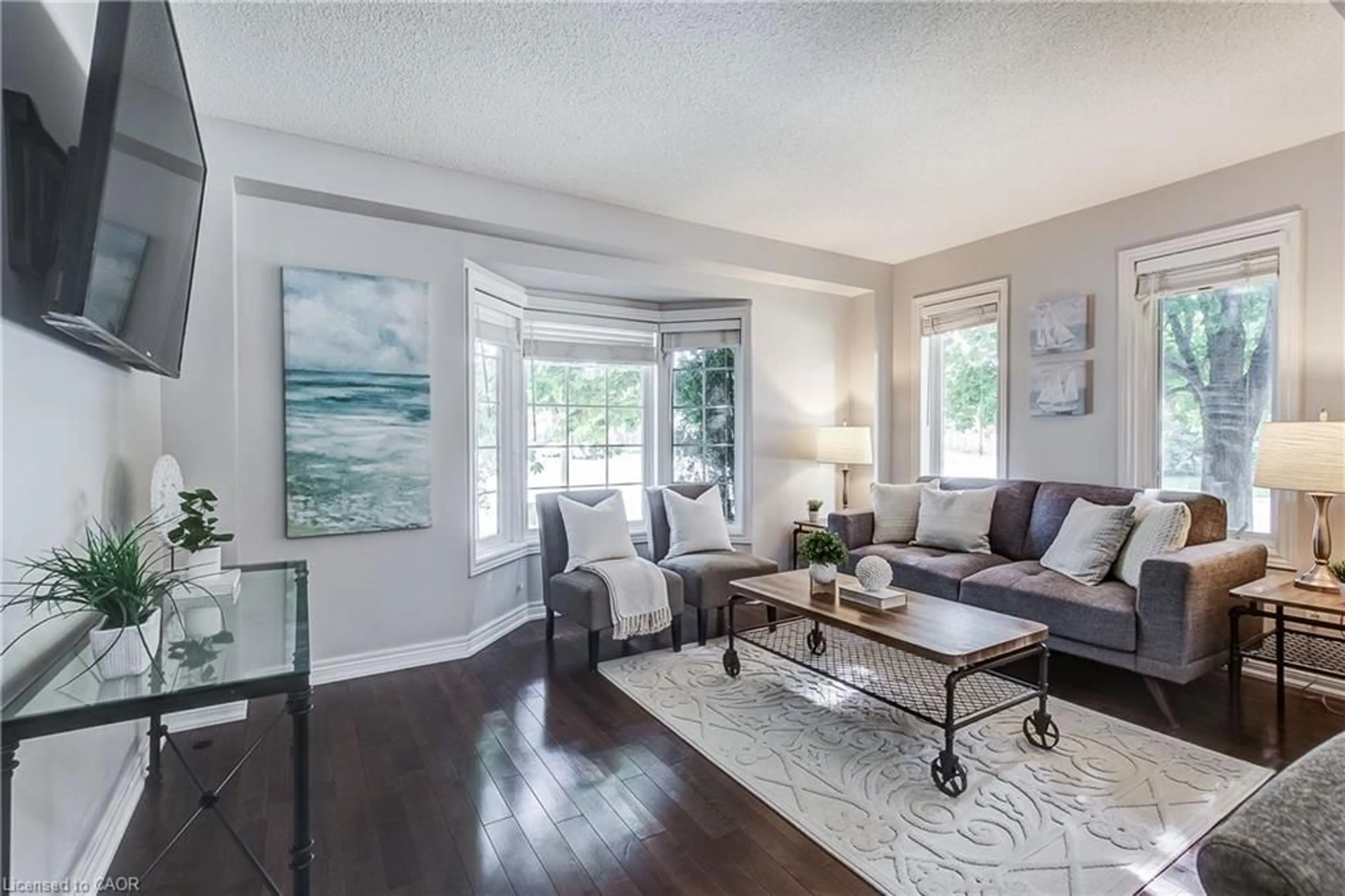 Living room with furniture, wood/laminate floor for 1749 Creek Way, Burlington Ontario L7L 7E1