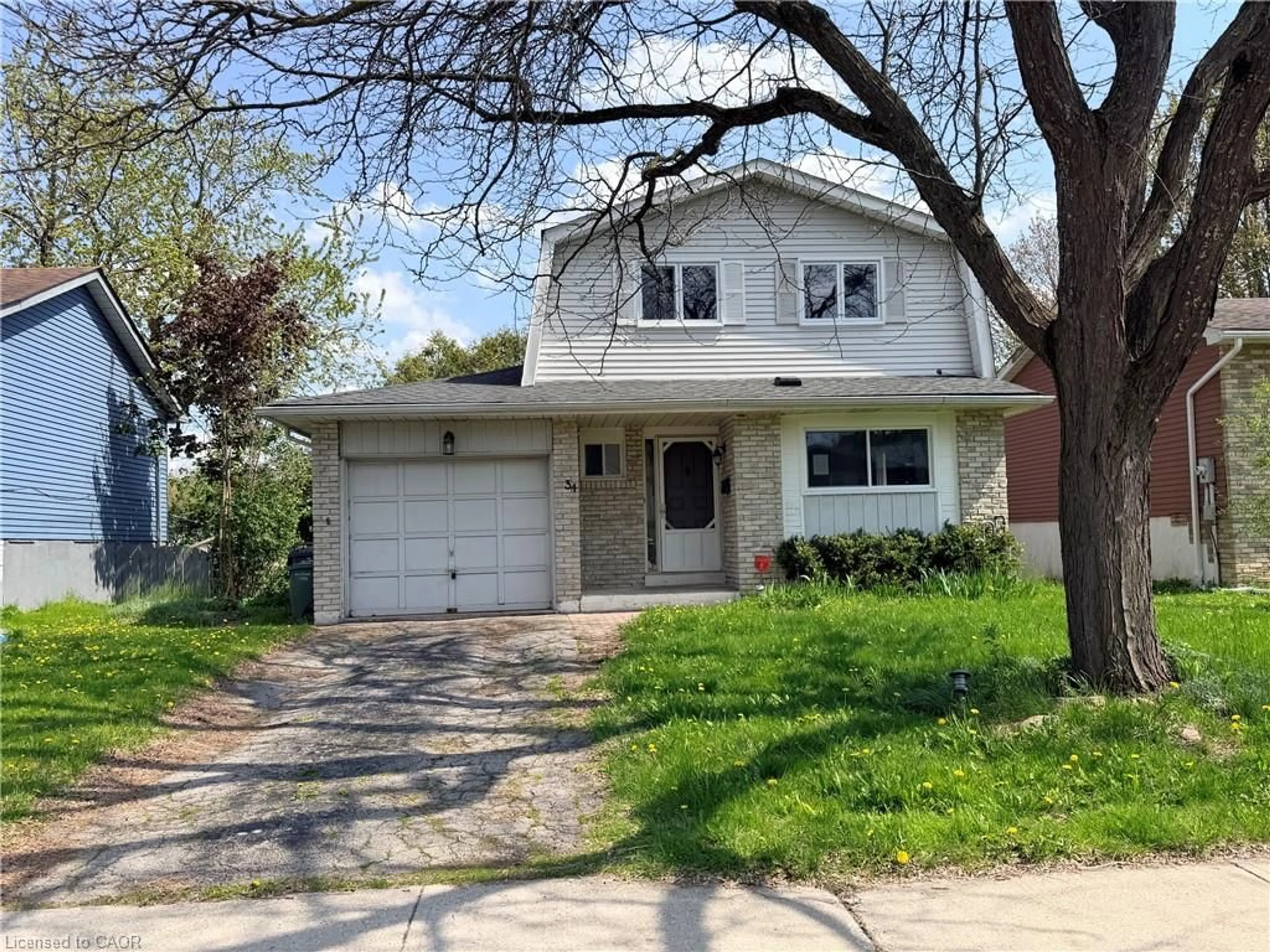 Home with vinyl exterior material, street for 34 Woodridge Dr, Guelph Ontario N1H 7E2