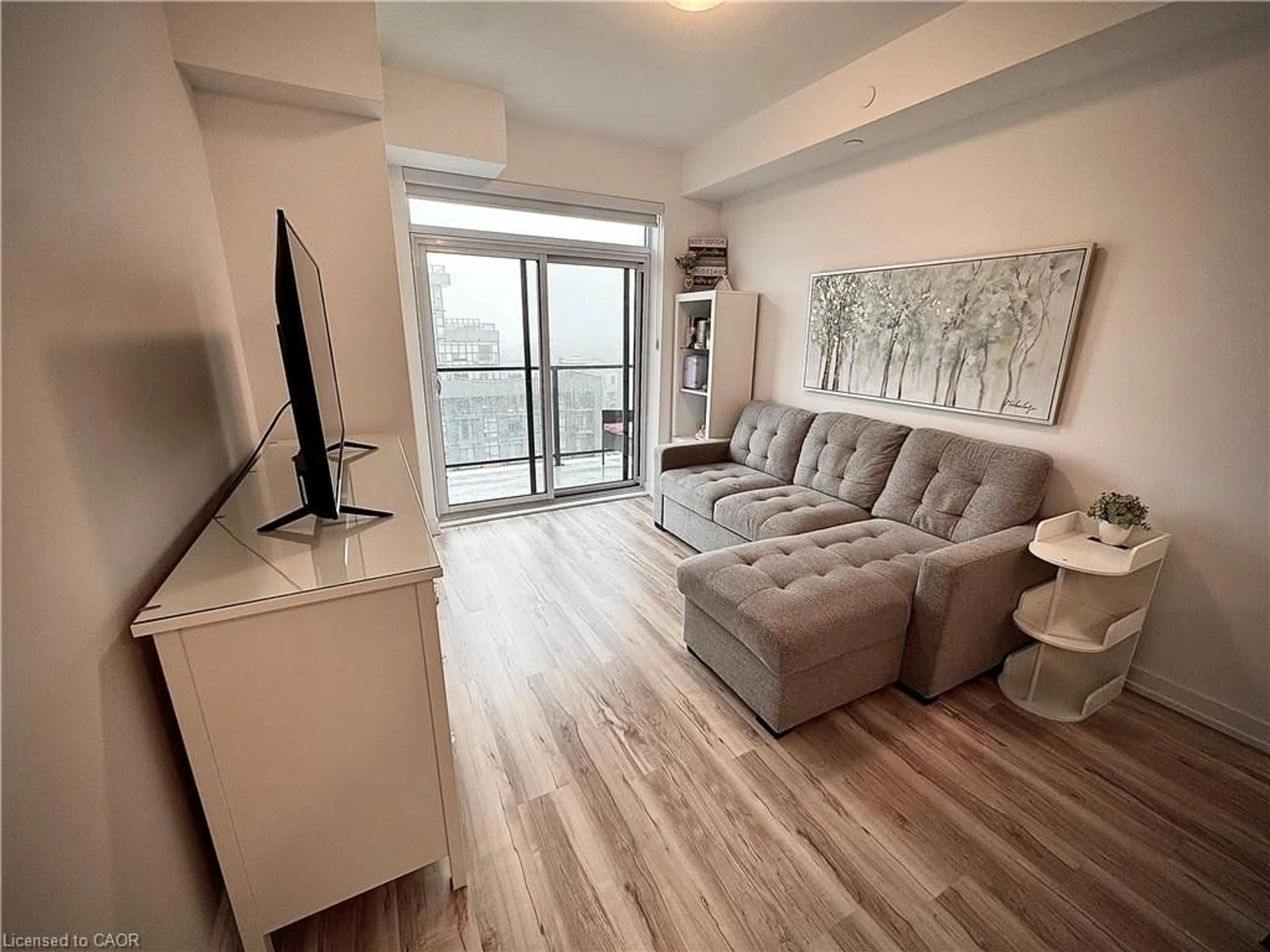 Living room with furniture, wood/laminate floor for 460 Dundas St #709, Waterdown Ontario L8B 2A5
