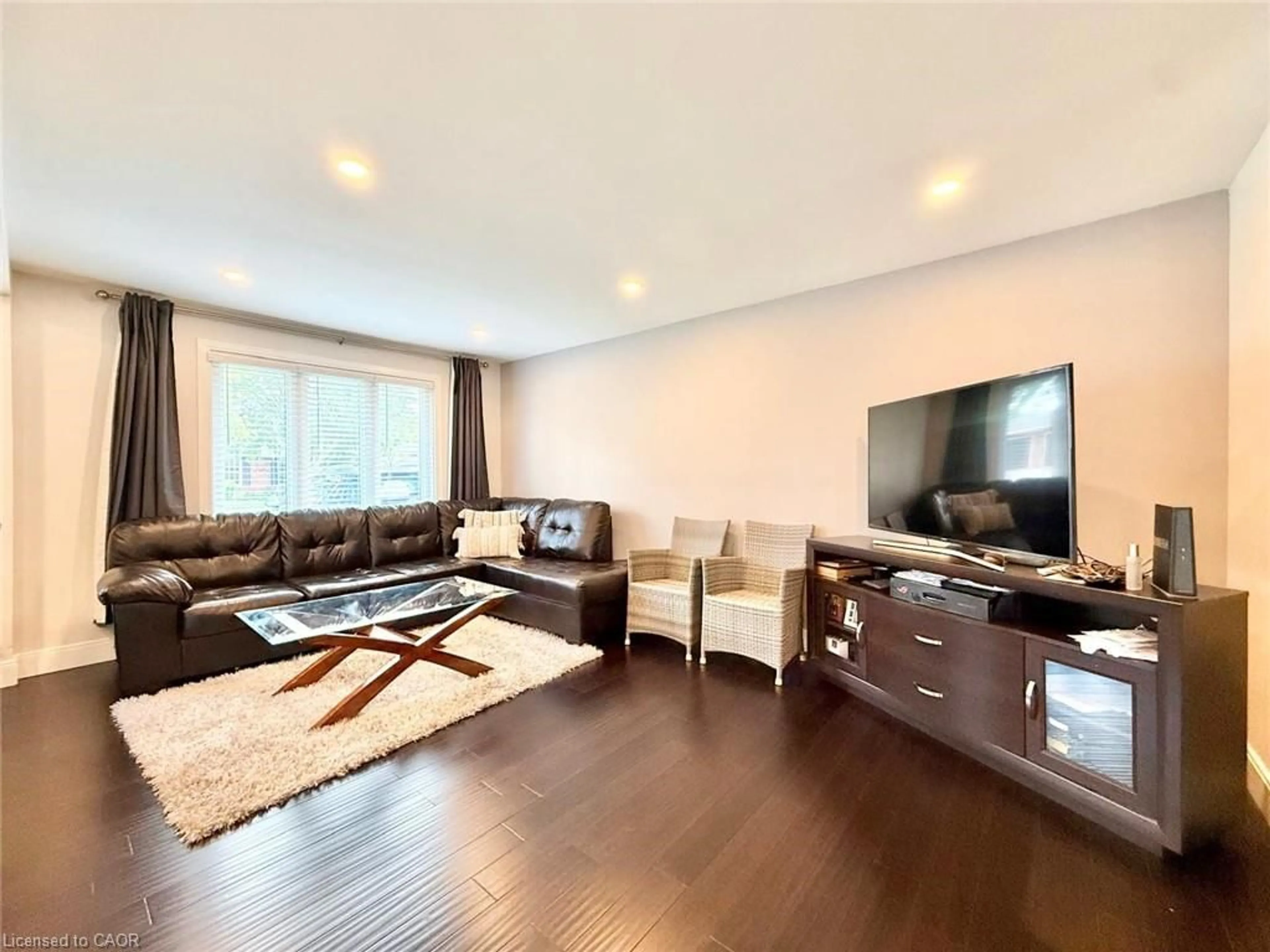 Living room with furniture, wood/laminate floor for 3135 Palmer Dr, Burlington Ontario L7M 1L2