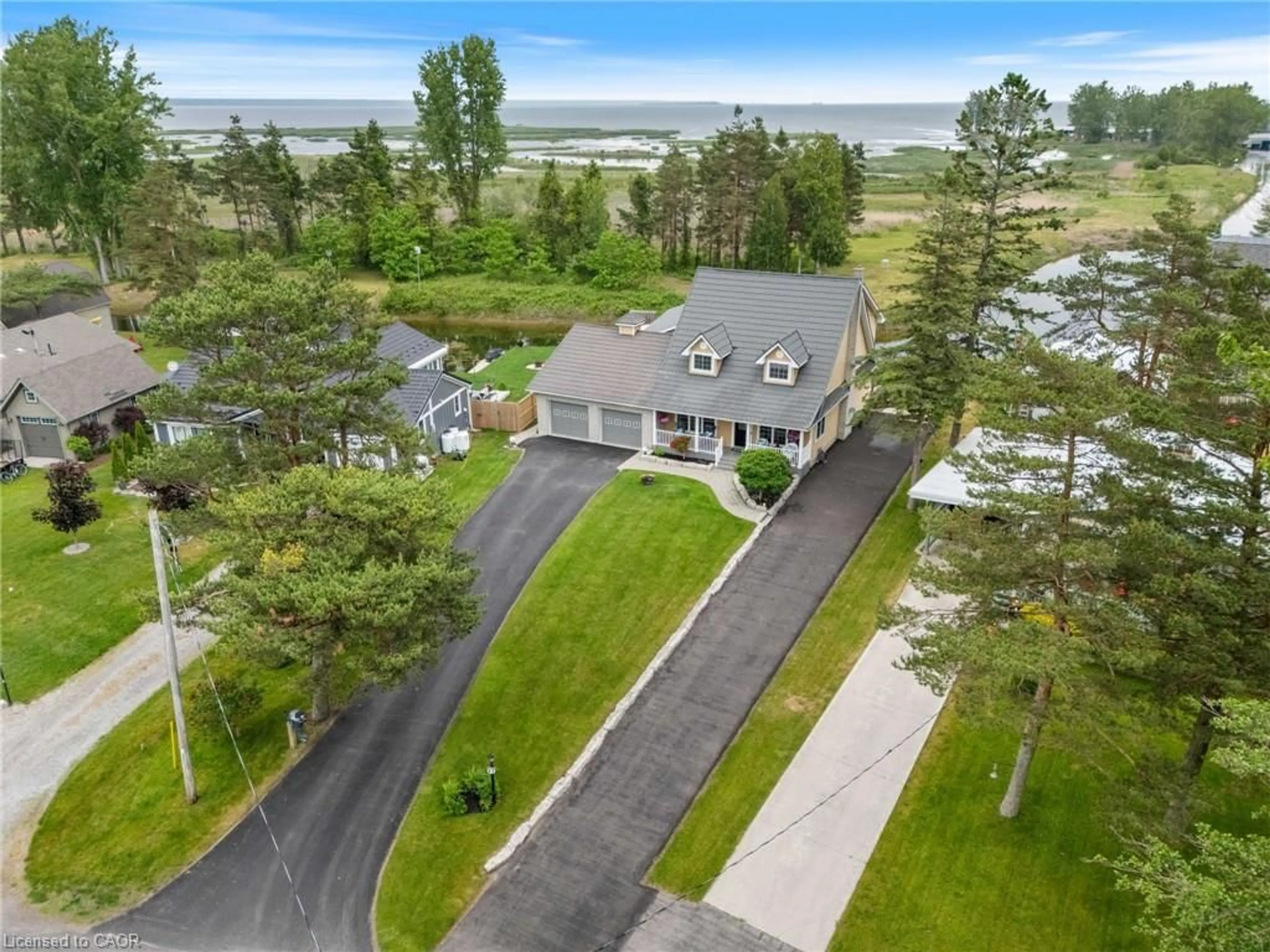 A pic from outside/outdoor area/front of a property/back of a property/a pic from drone, water/lake/river/ocean view for 43 Old Cut Blvd, Long Point Ontario N0E 1M0