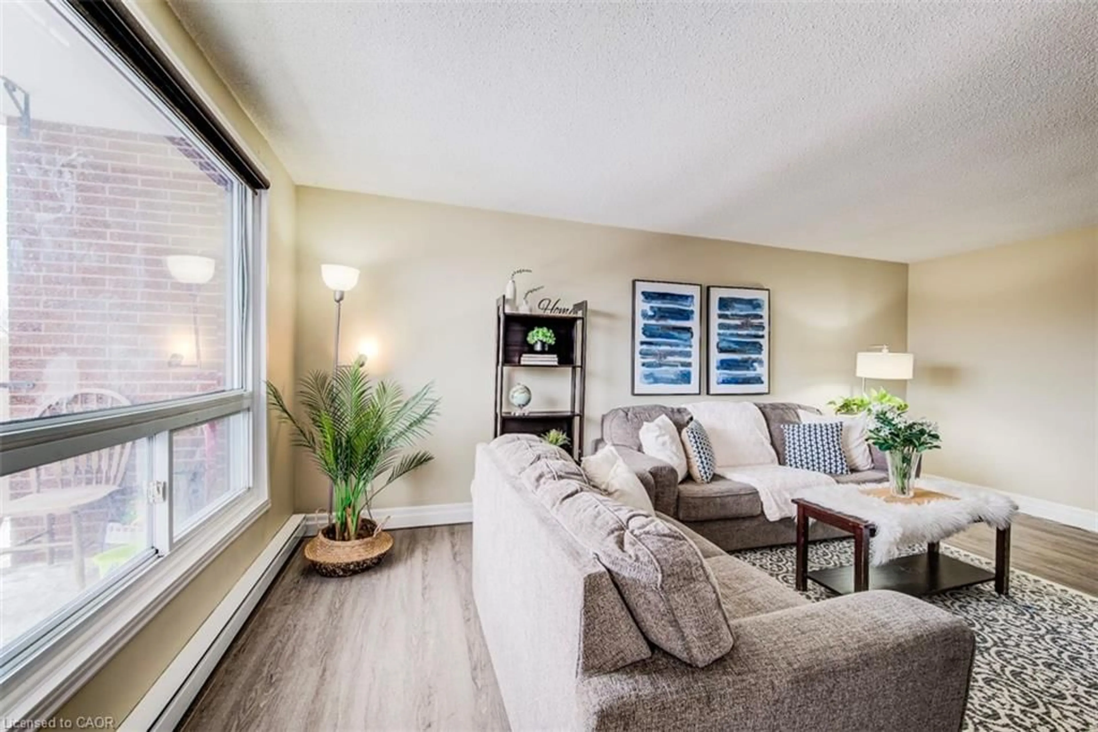 Living room with furniture, wood/laminate floor for 303-4 Avalon Pl, Kitchener Ontario N2M 4N6